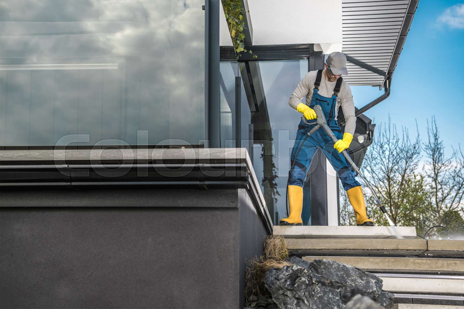 Cleaning Backyard Garden Concrete Paths Using Pressure Washer Stock