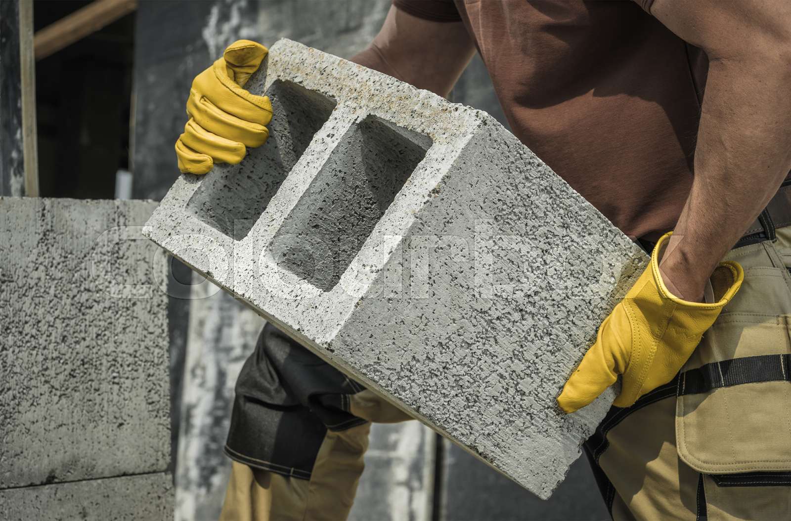 Construction Worker Moving Hollow Dense Concrete Blocks Stock image