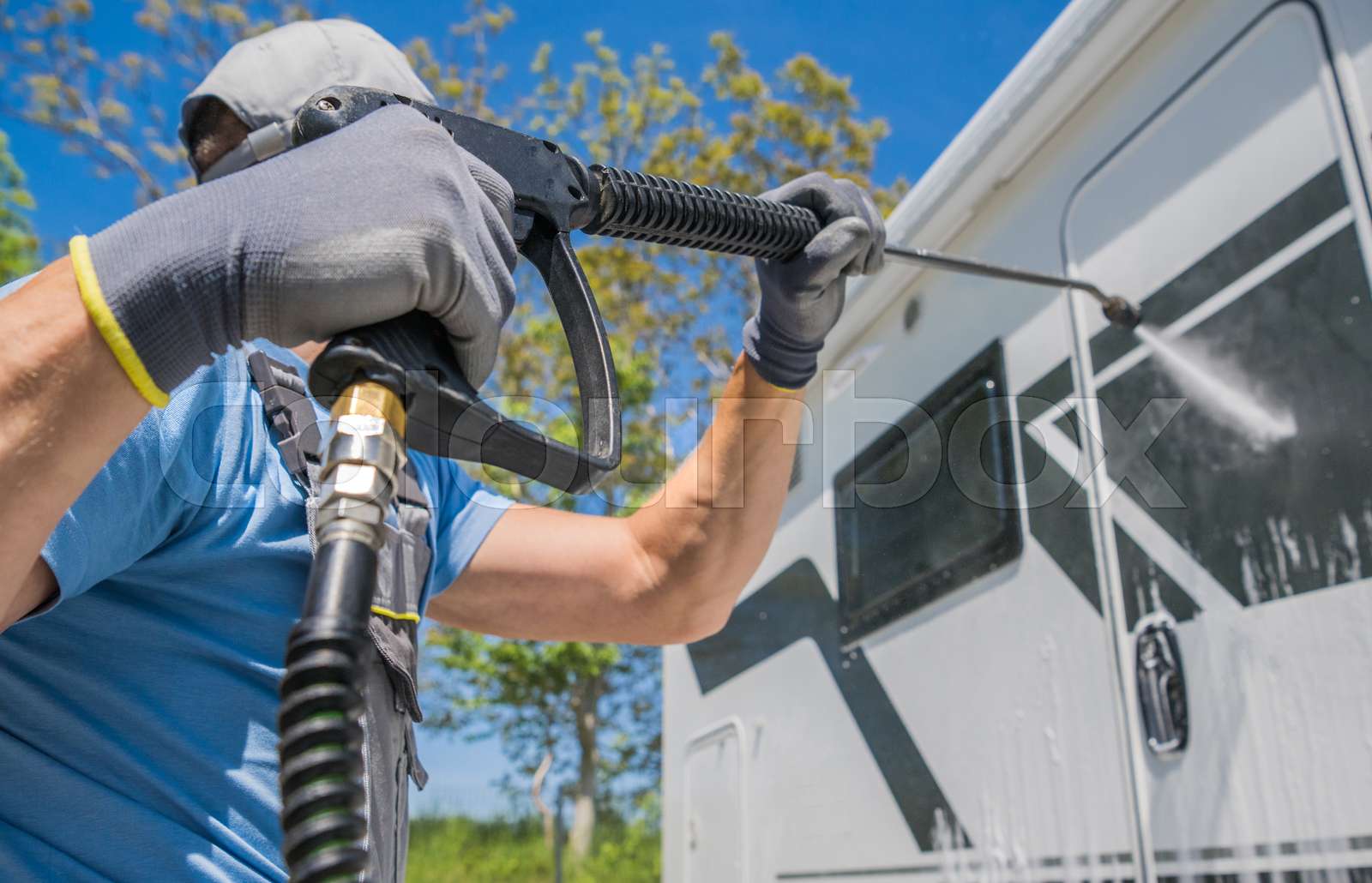 Powerful Pressure Washing of a Camper Van Motorhome RV Stock image