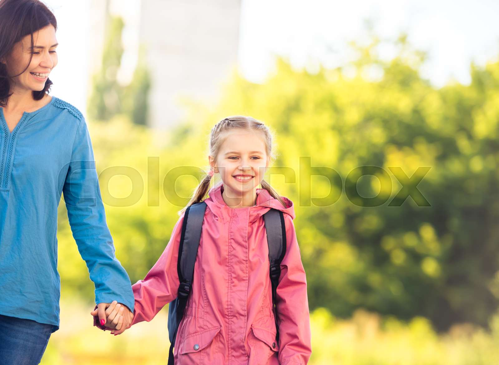 Little girl going to school with mother | Stock image | Colourbox