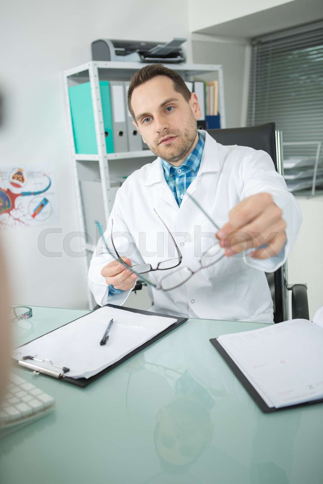 doctor giving eyeglasses to patient Stock image Colourbox