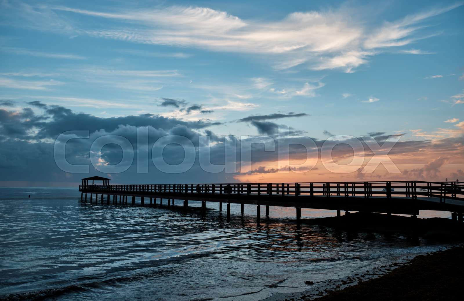 Long pier in the ocean in the morning. Stock image Colourbox