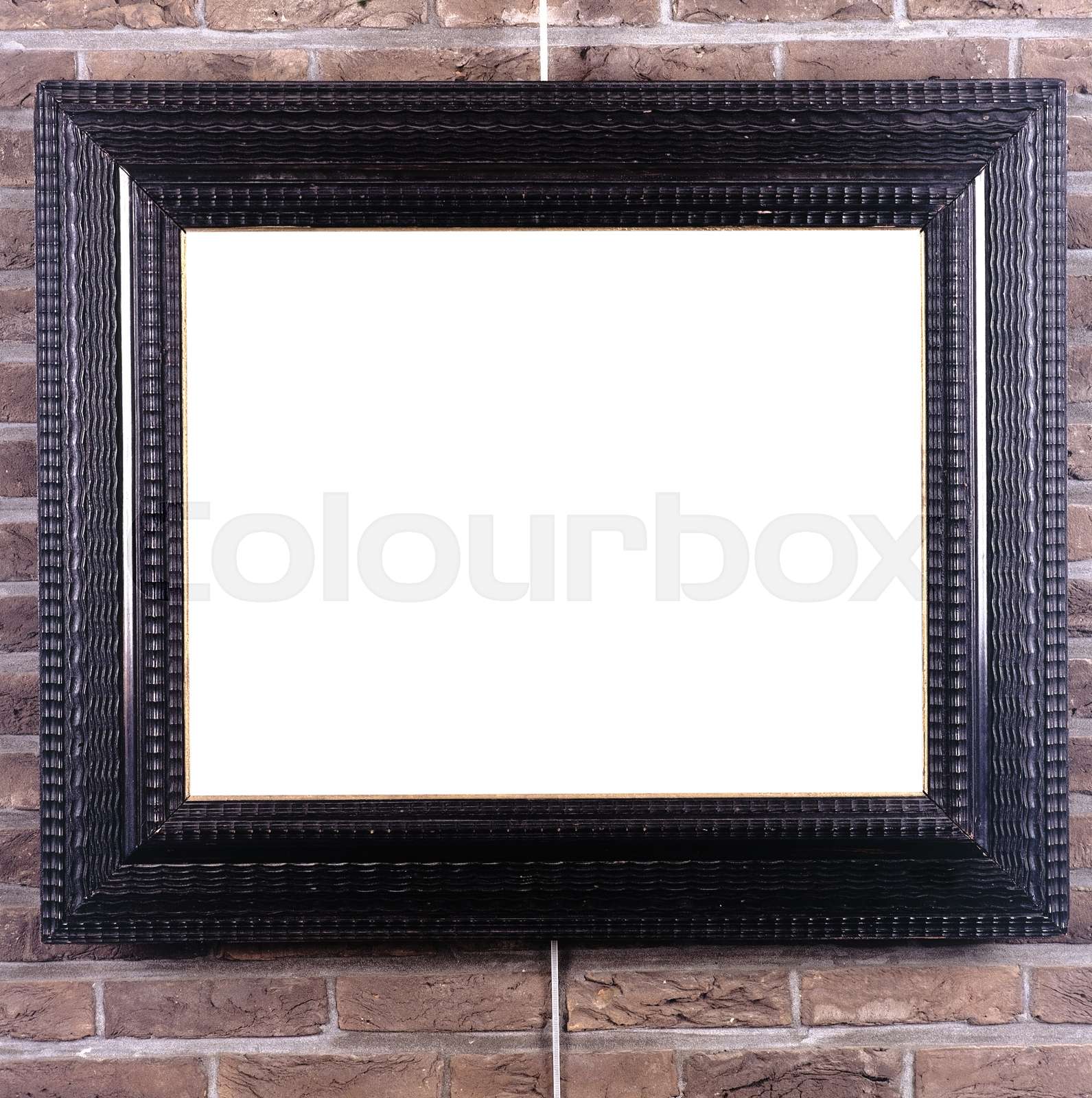Picture frame hung on the wall by a picture rail Stock image Colourbox