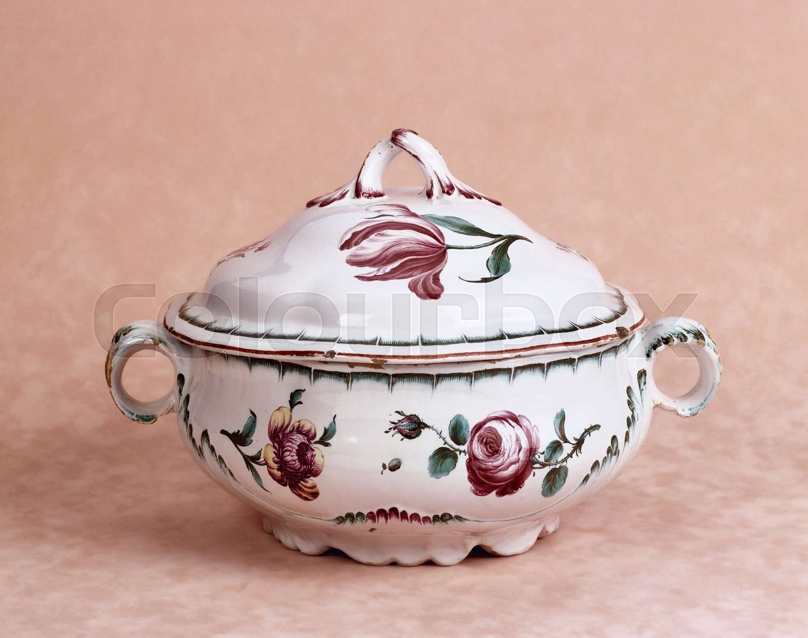Antique porcelain tureen with floral scene in colors Stock image