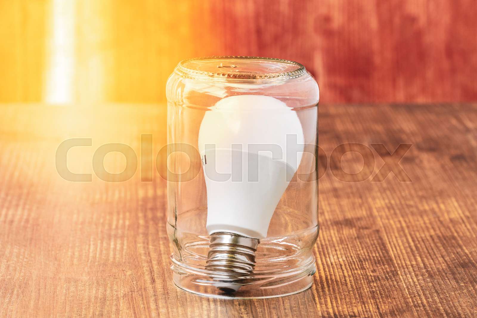 Light bulb inside glass jar Stock image Colourbox
