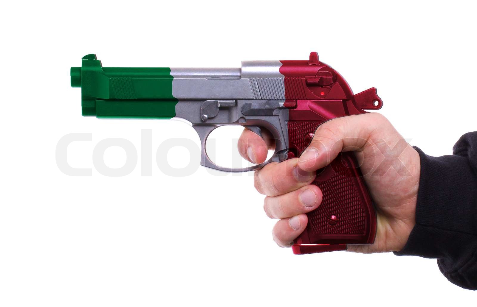 Pistol with Italian flag pattern in hand | Stock image | Colourbox