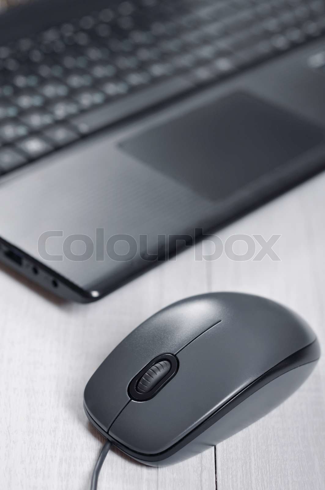 Laptop with computer mouse | Stock image | Colourbox