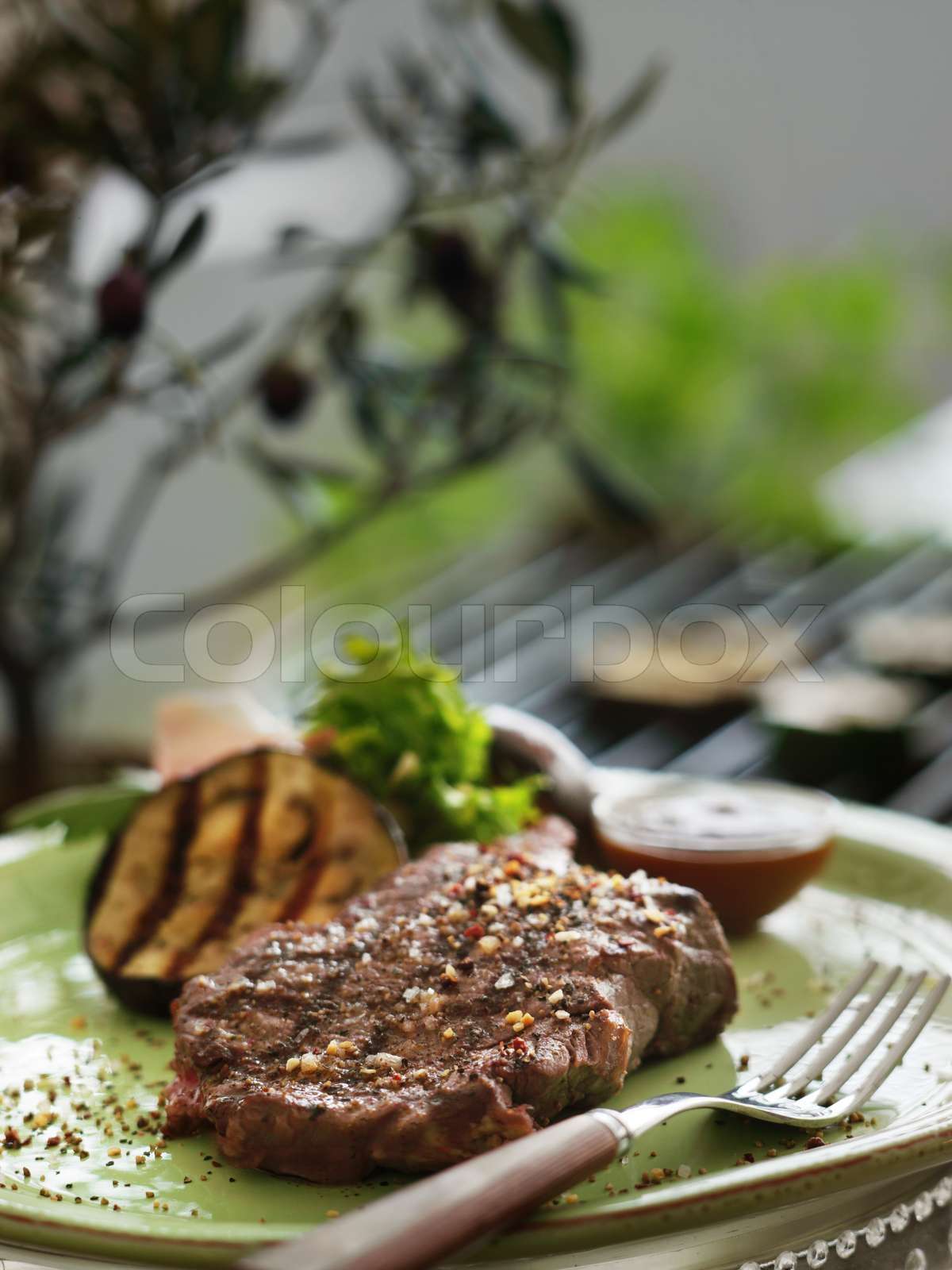 A plate with grilled steak and vegetables Stock image Colourbox