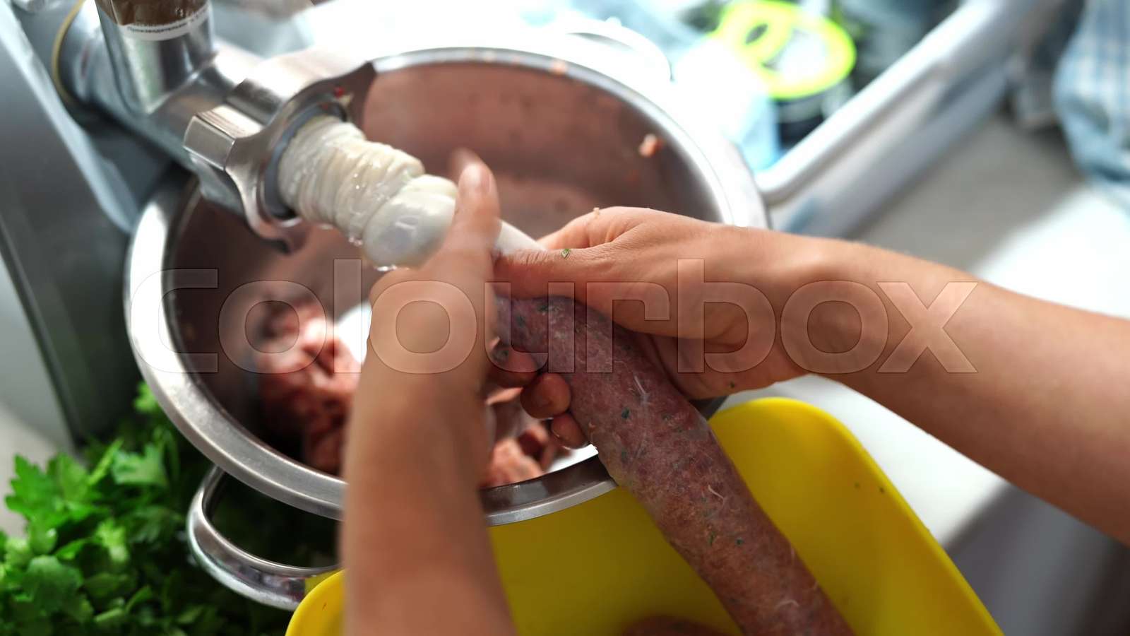 Man and woman making sausages on an electric meat grinder Stock video