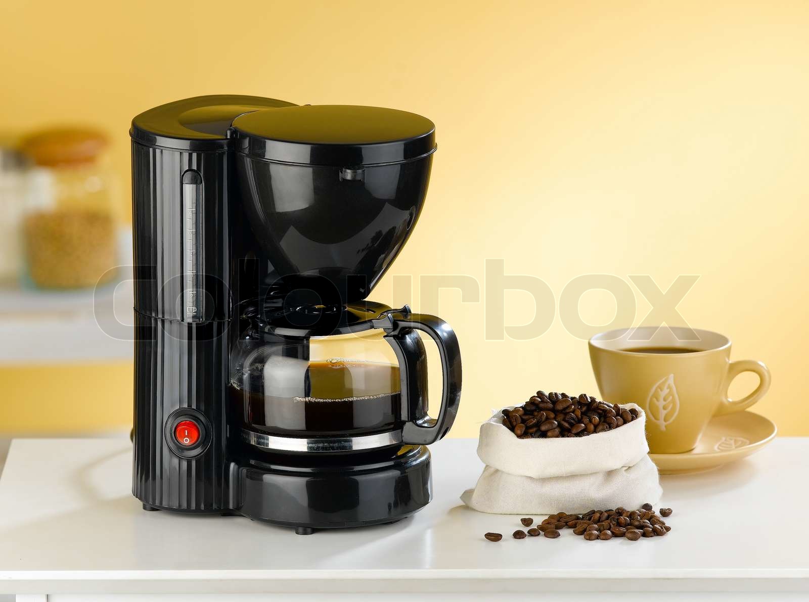 Coffee blender and boiler with coffee seeds in a kitchen interior