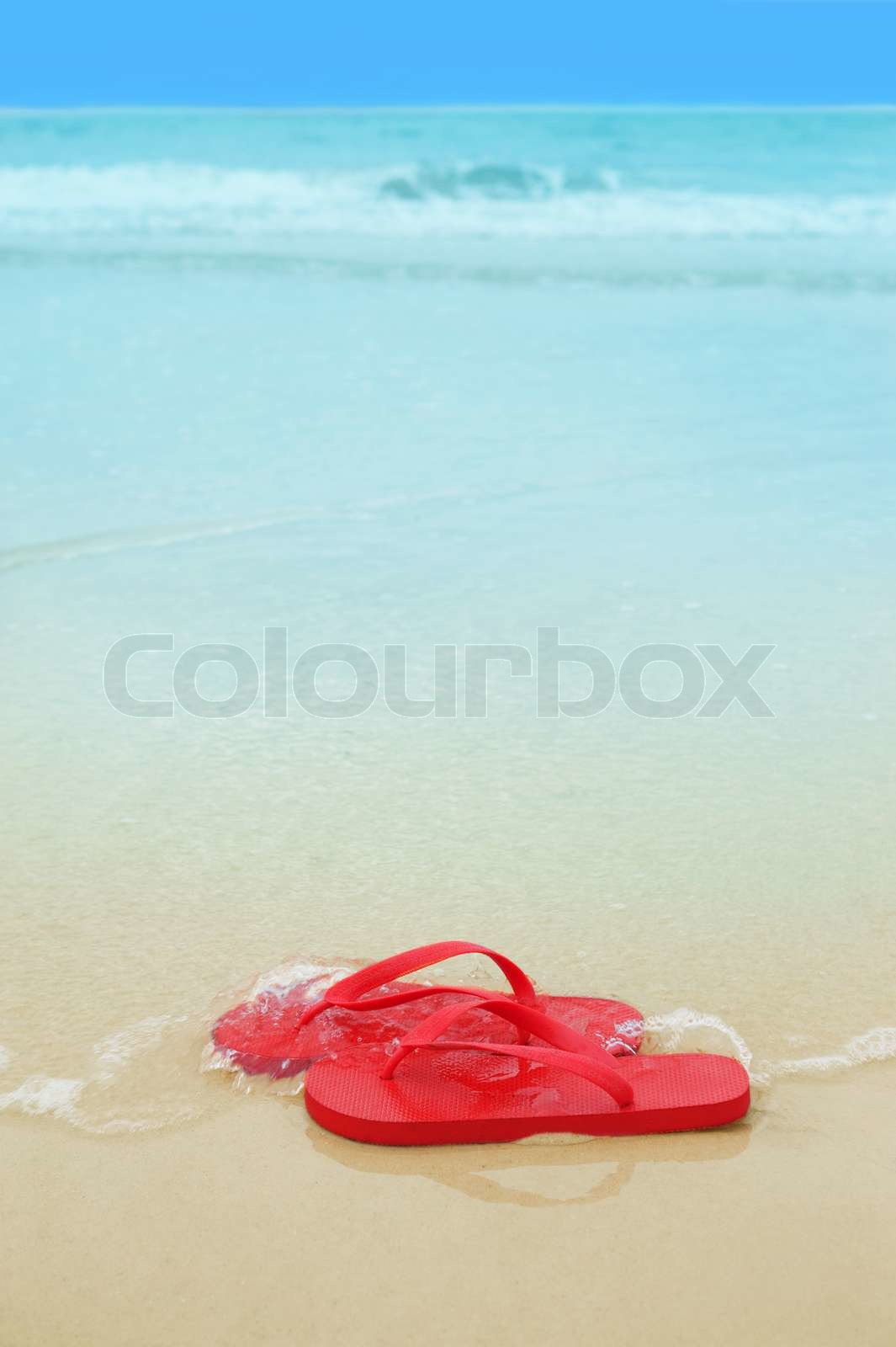 Red flip flops on the beach | Stock image | Colourbox