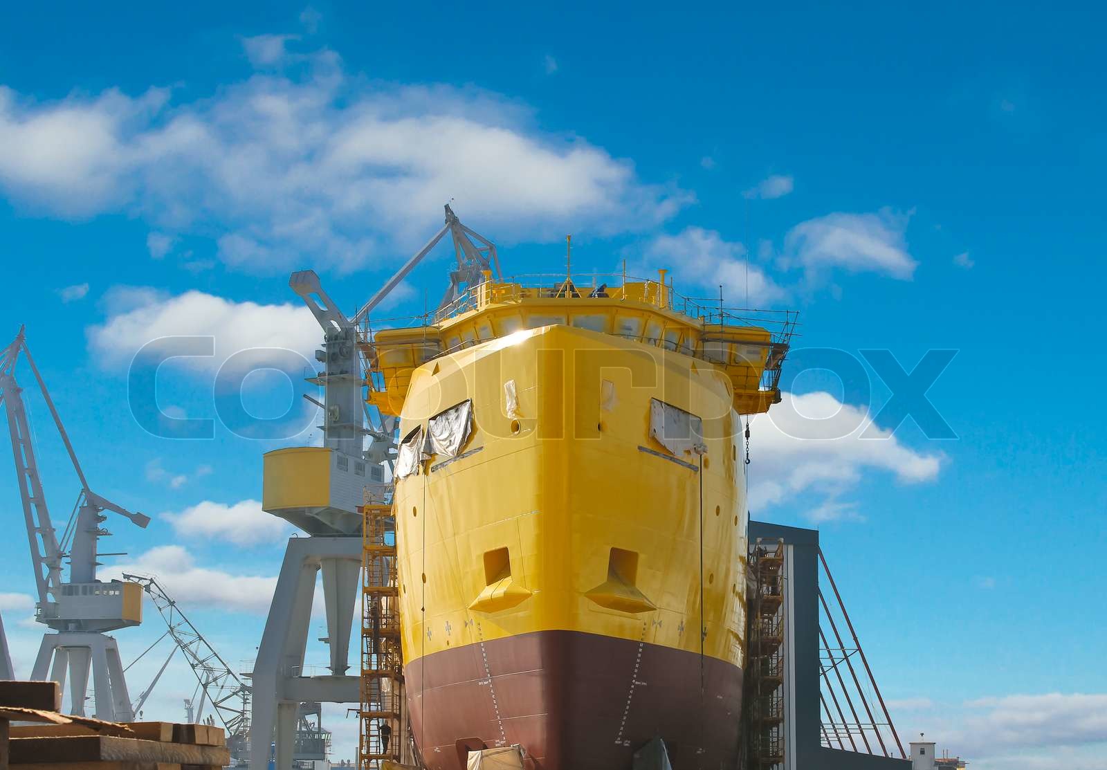 The construction of a new ship in dry dock shipyard | Stock image