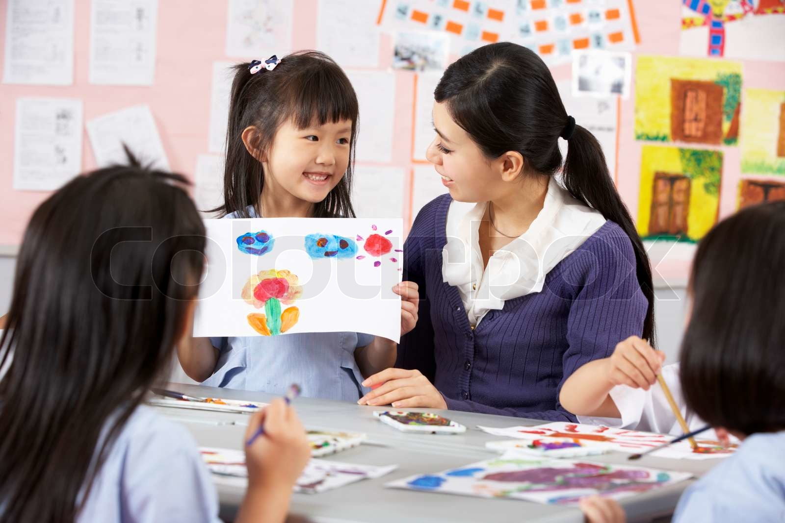 Teacher Helping Students During Art Class In Chinese School Classroom ...