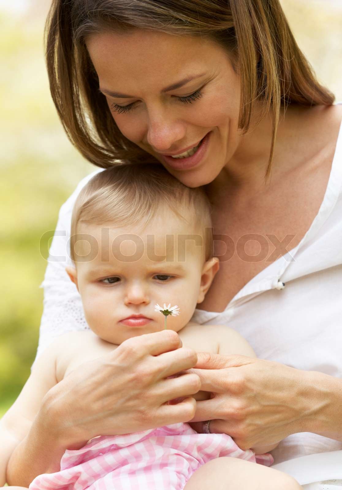 Mother Sitting With Baby Girl In Field Of Summer Flowers Stock Image