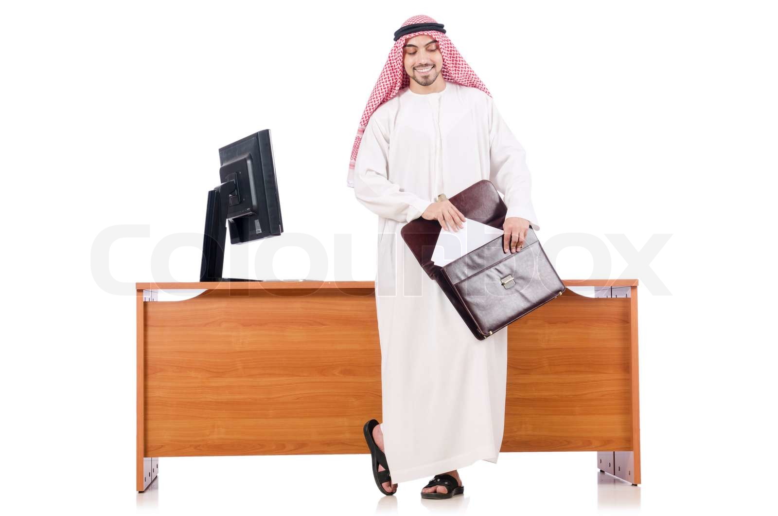 Arab man sitting at his desk | Stock image | Colourbox