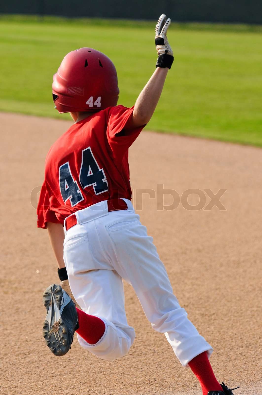Little league player running bases Stock image Colourbox