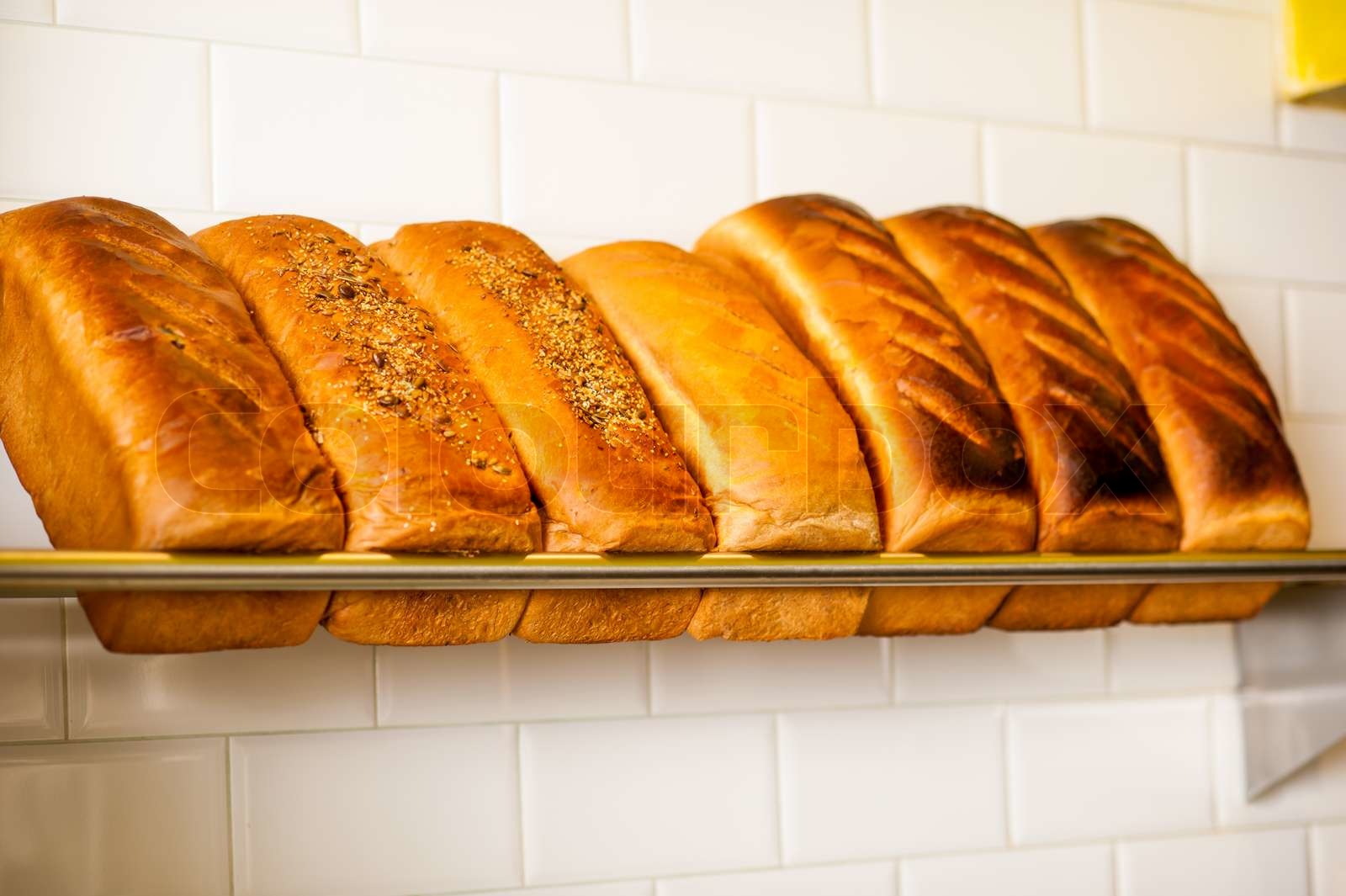 Freshly kneaded grain and white breads for sale Stock image Colourbox