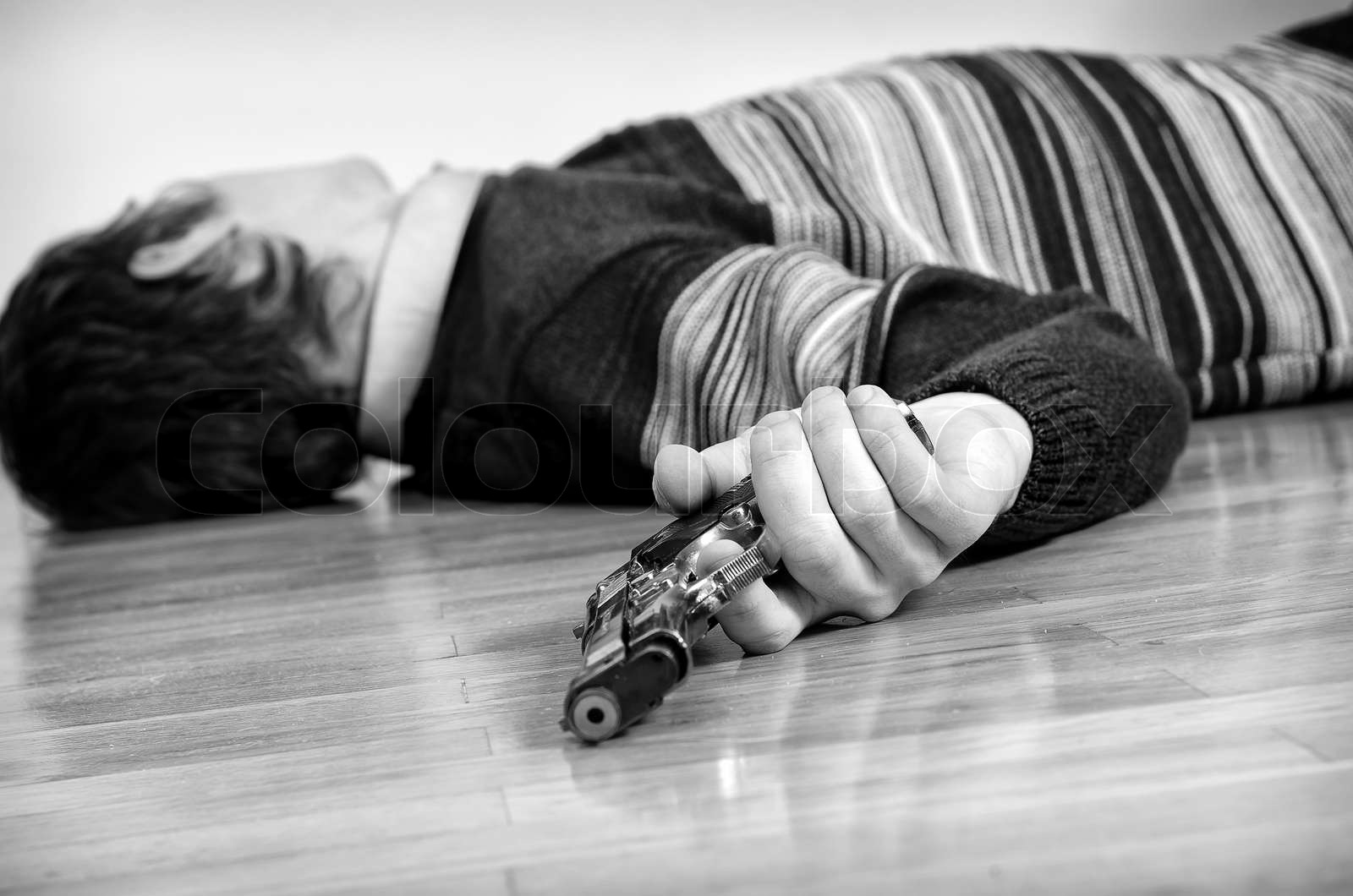 Man with gun laying on the floor Black and white Stock image Colourbox
