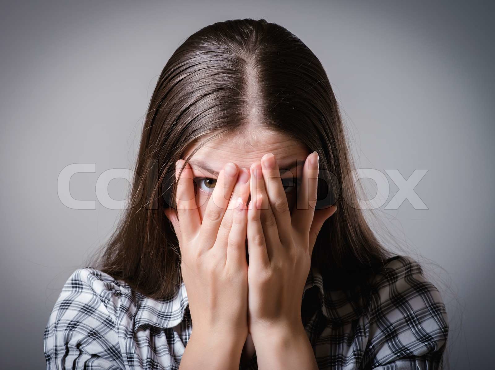 girl covers her face Stock image Colourbox