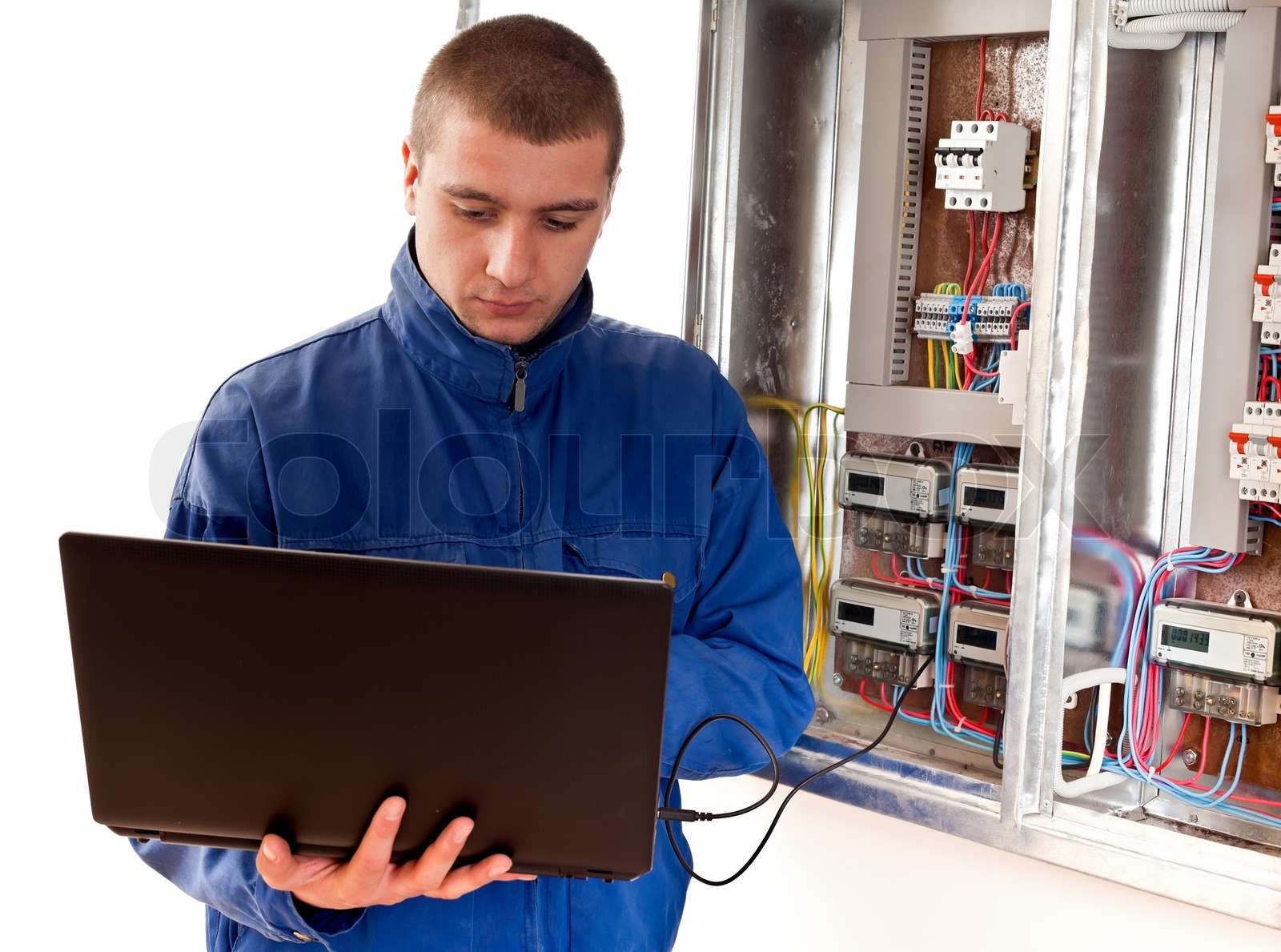 Electrician working with laptop | Stock image | Colourbox