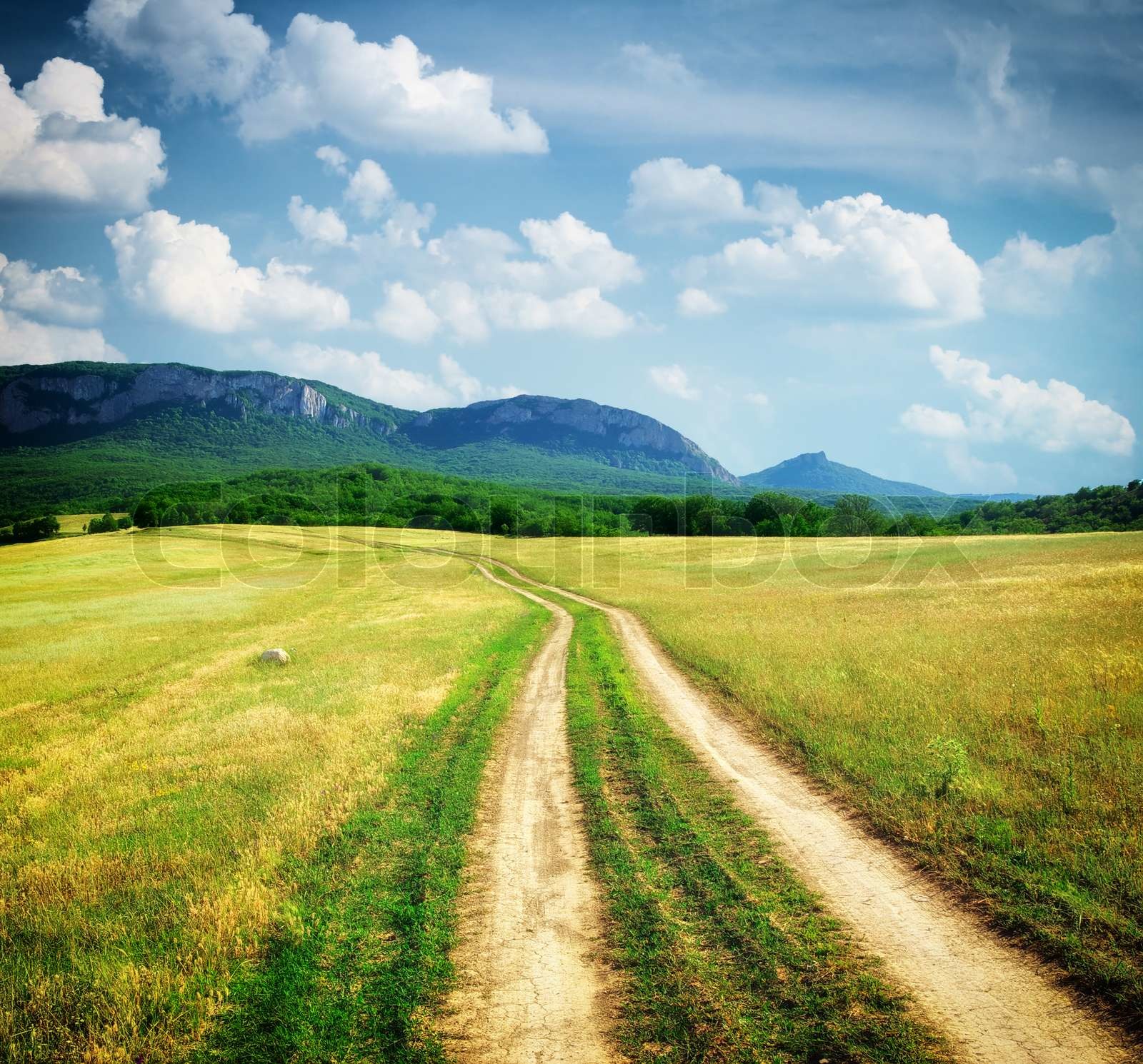 Road lane in mountain meadow Stock image Colourbox