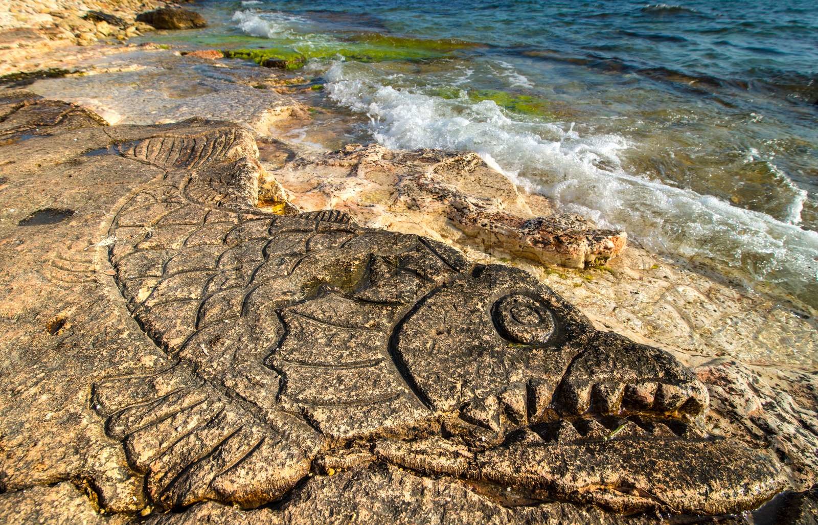 Rock carvings on the beach | Stock image | Colourbox