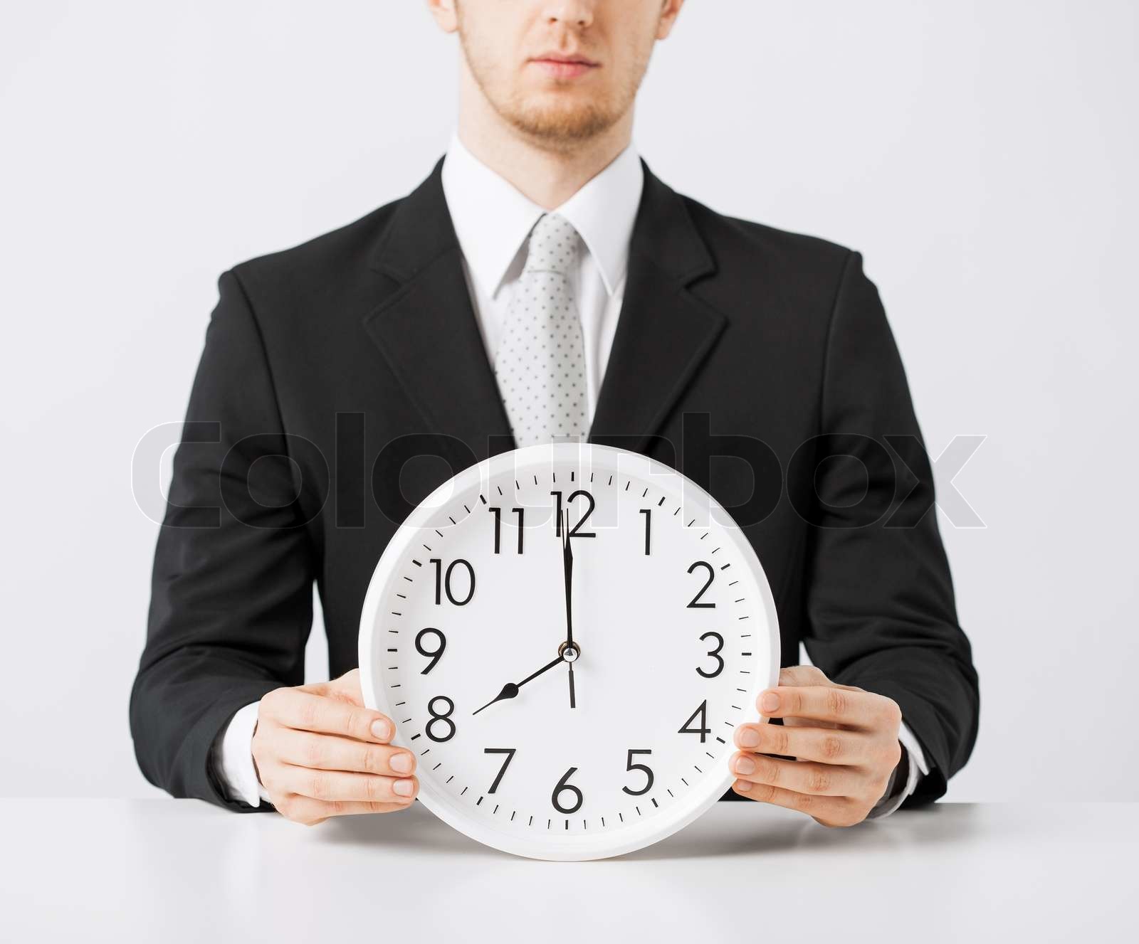 man with wall clock | Stock image | Colourbox