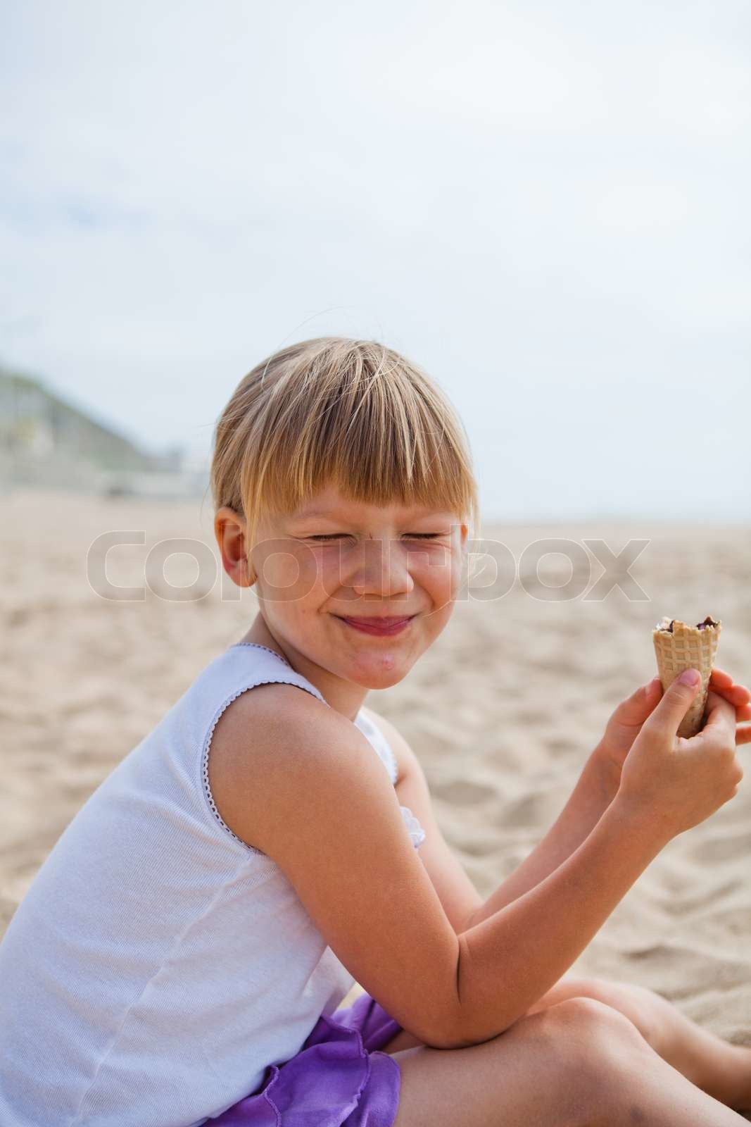 Happy girl with ice cream on beach | Stock image | Colourbox