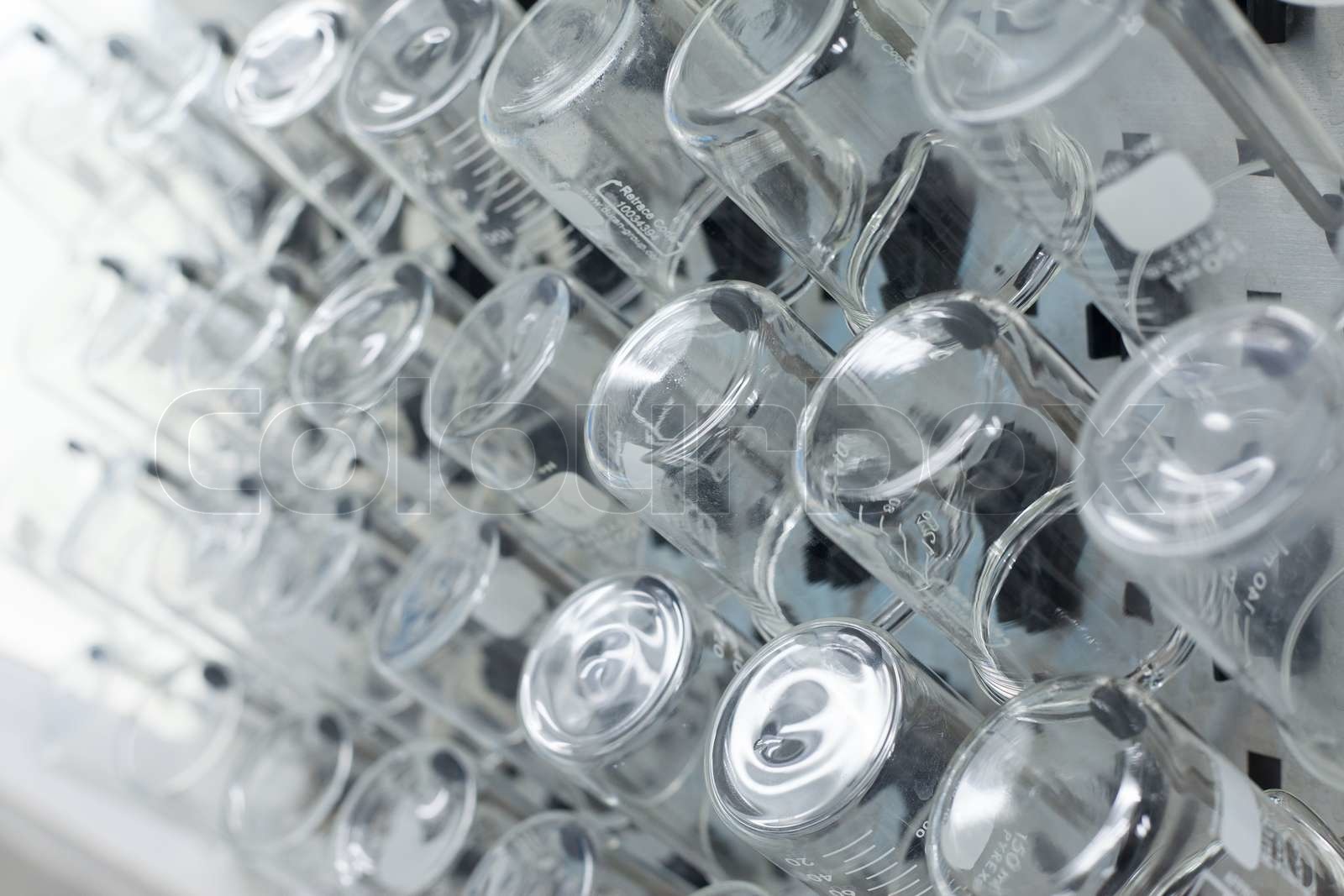 Rows of beaker on a drying rack in a chemistry lab Stock image