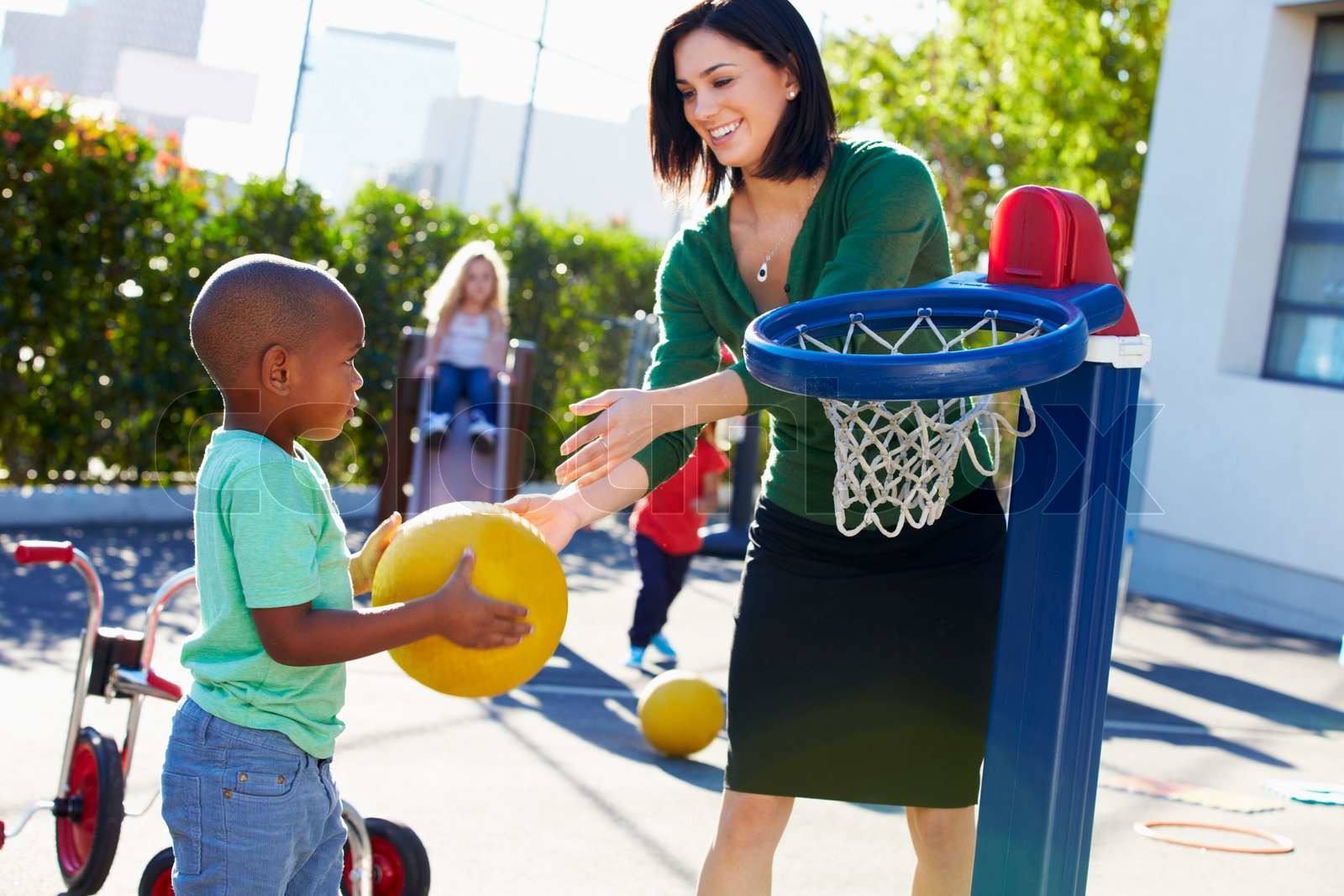 Teacher Supervising Breaktime At Elementary School Stock image