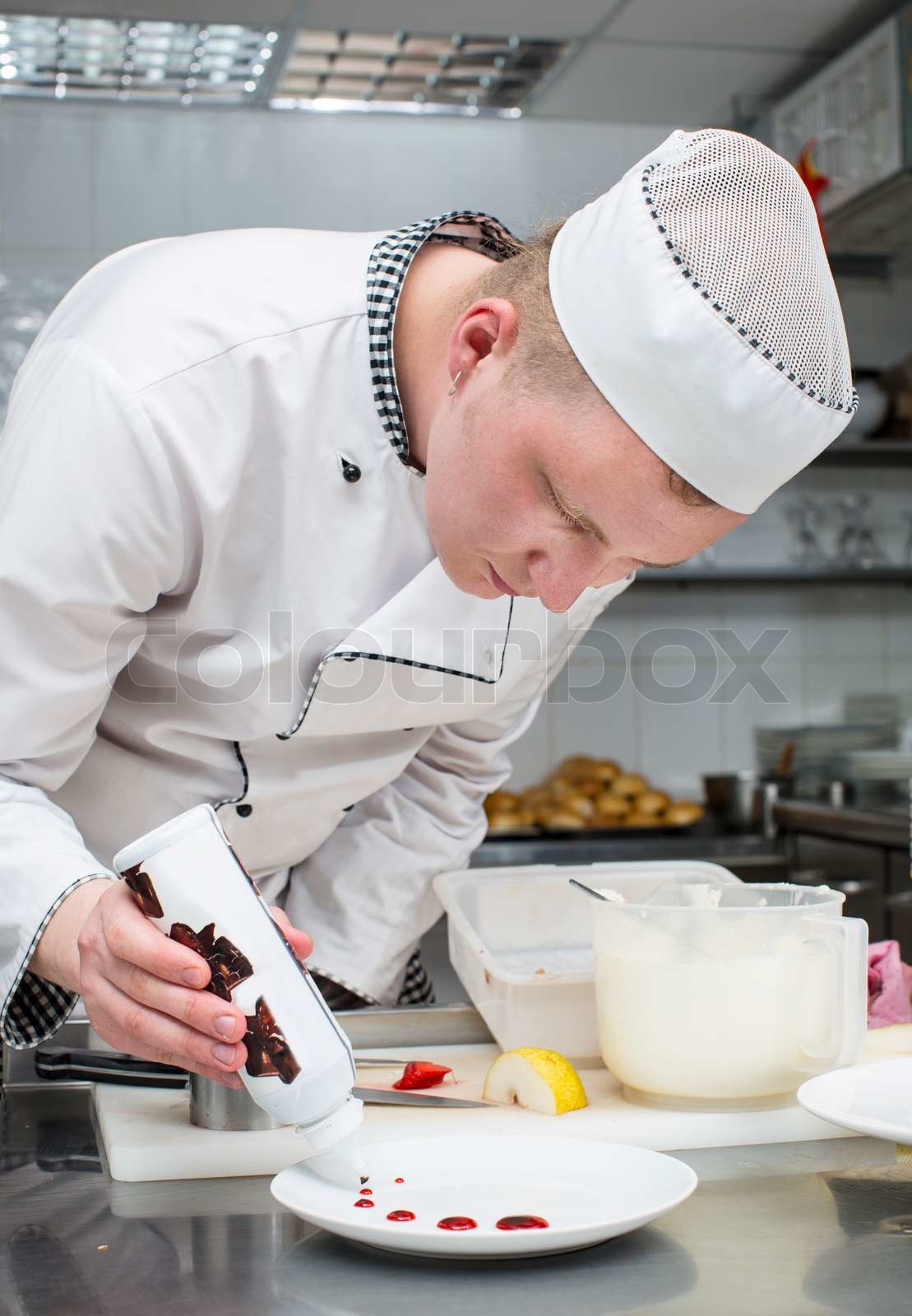 chef preparing food in the kitchen at the restaurant | Stock image