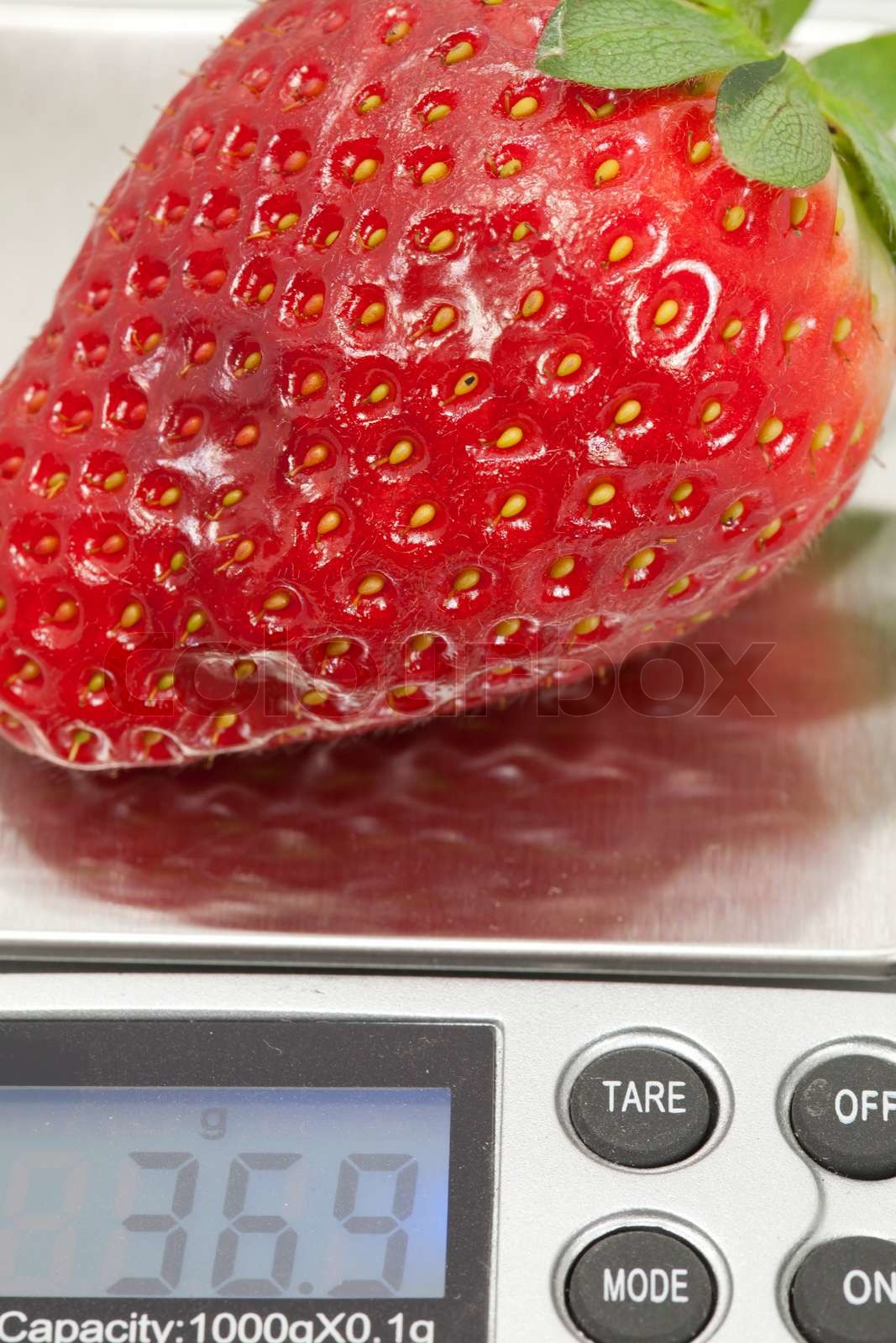 Weighing a strawberry | Stock image | Colourbox
