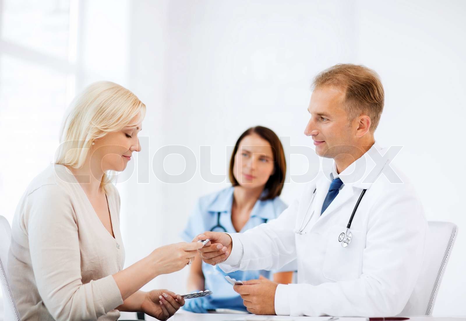 doctor-giving-tablets-to-patient-in-hospital-stock-image-colourbox