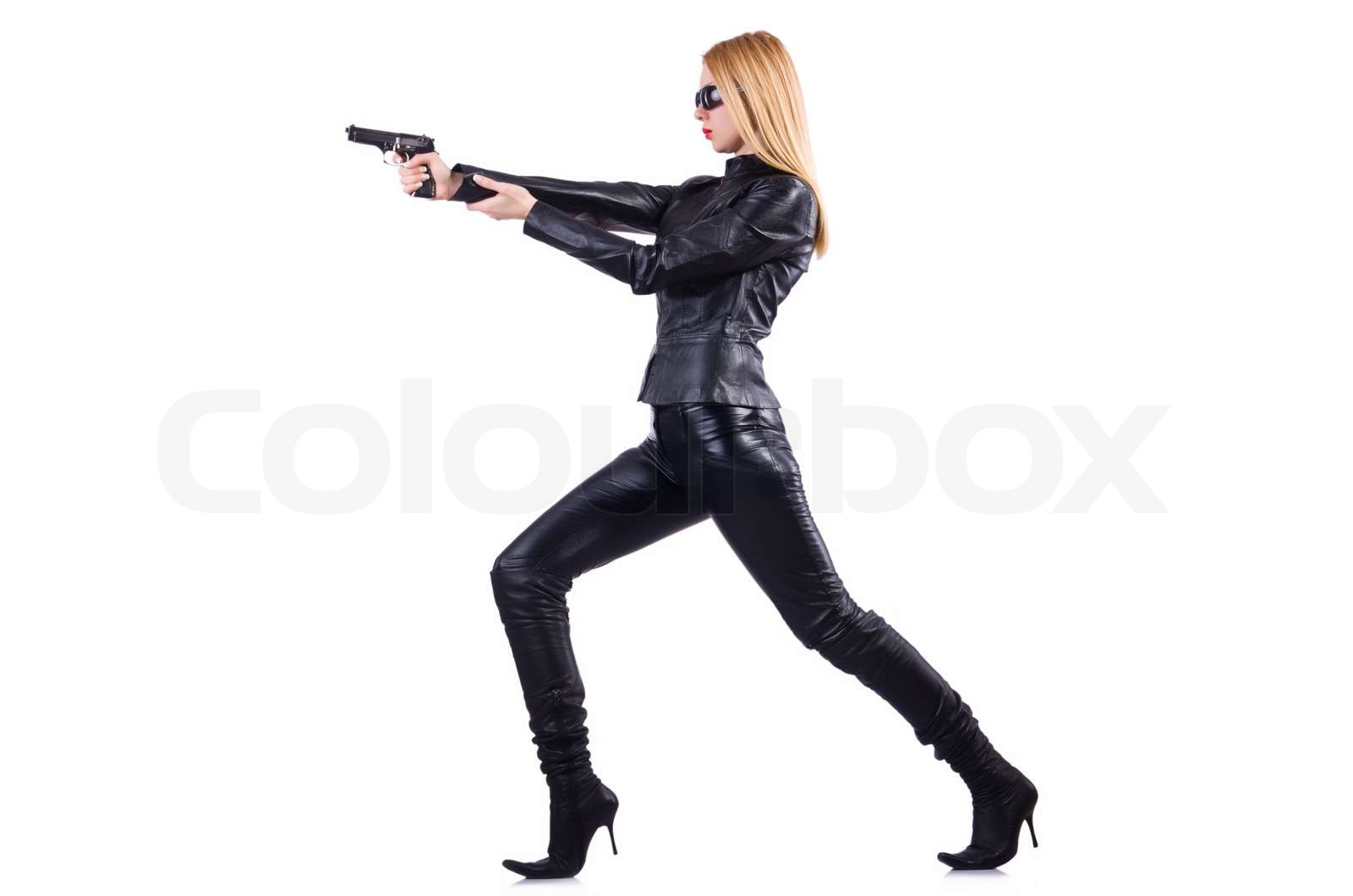 Woman with gun in black leather costume | Stock image | Colourbox