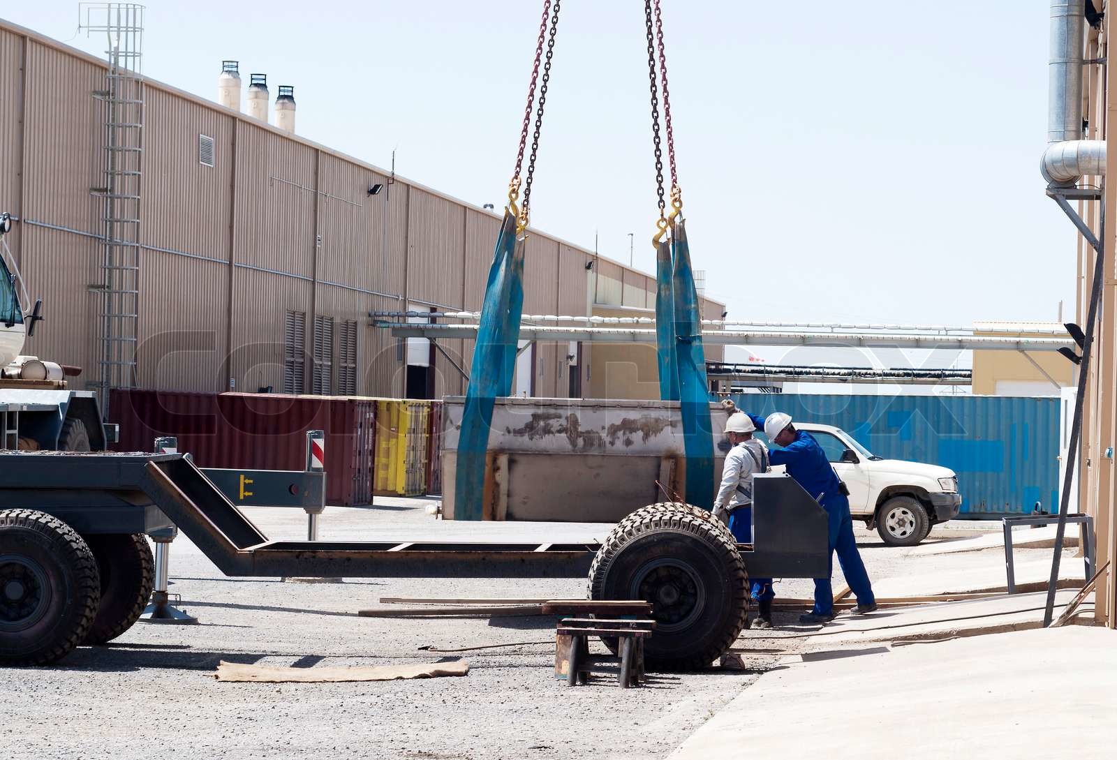 Unloading of steel capacity on industrial area | Stock image | Colourbox