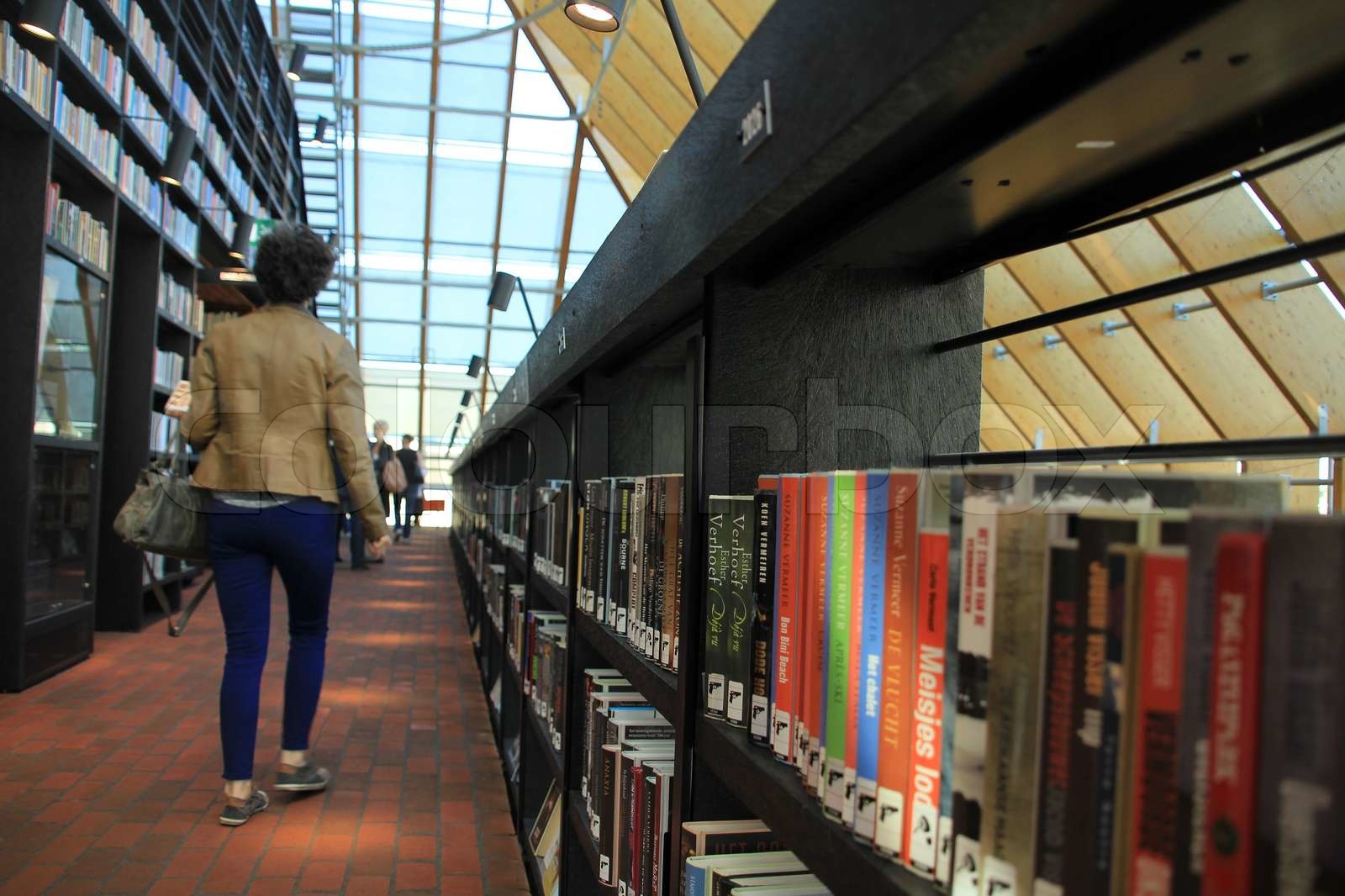 Walking in the library. Stock image Colourbox