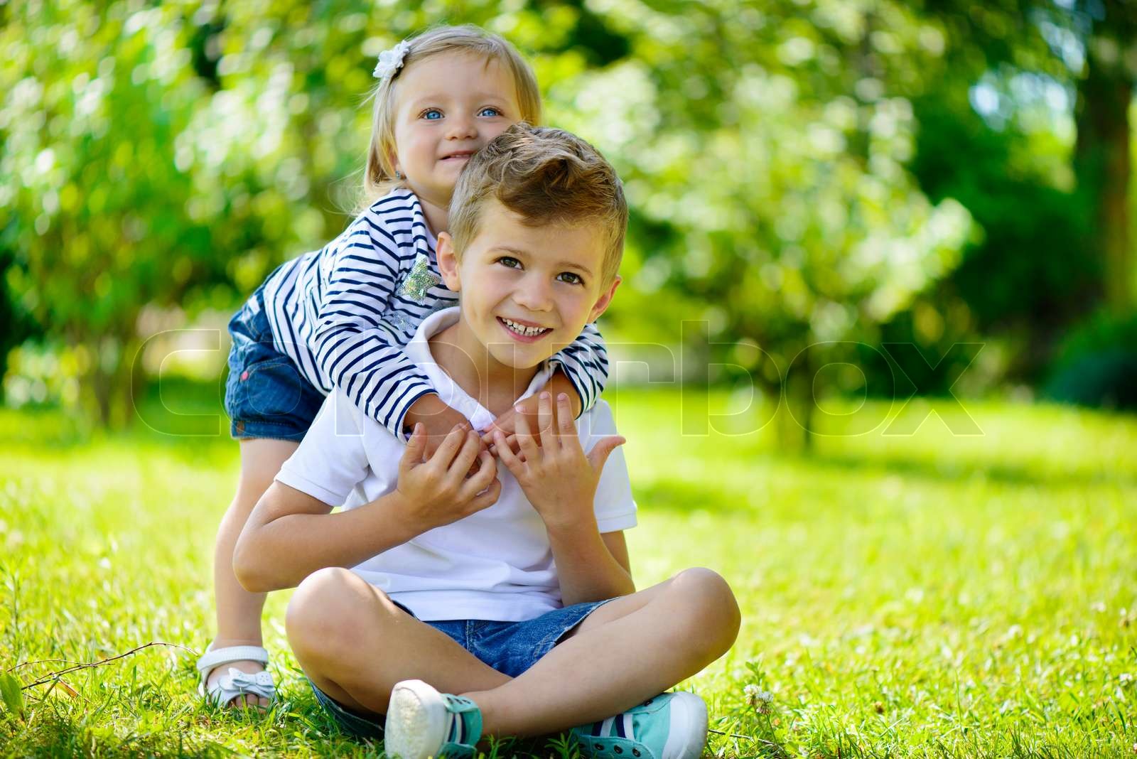 Happy sister and brother together in park | Stock image | Colourbox