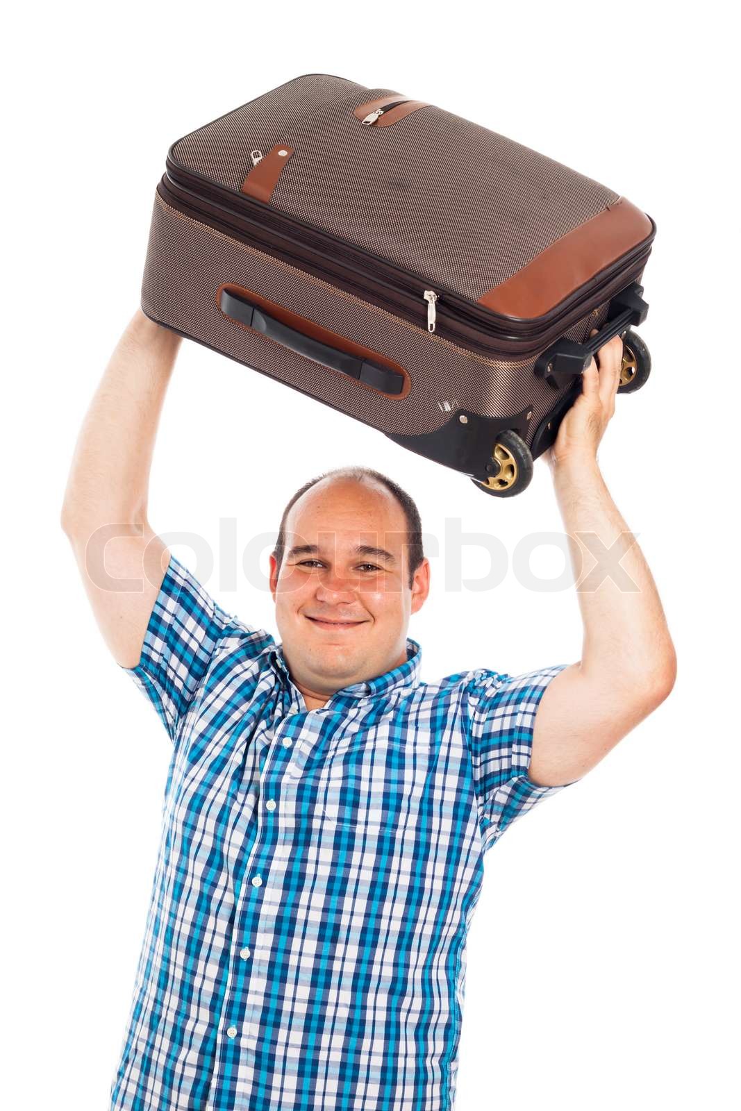 Happy traveler lifting up his luggage Stock image Colourbox