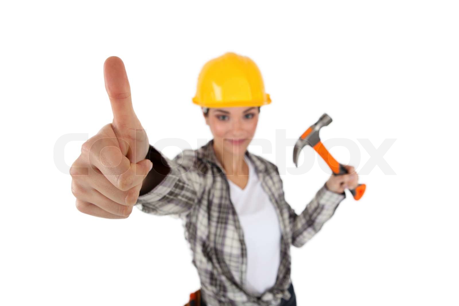 Woman with hammer giving thumbs up Stock image Colourbox