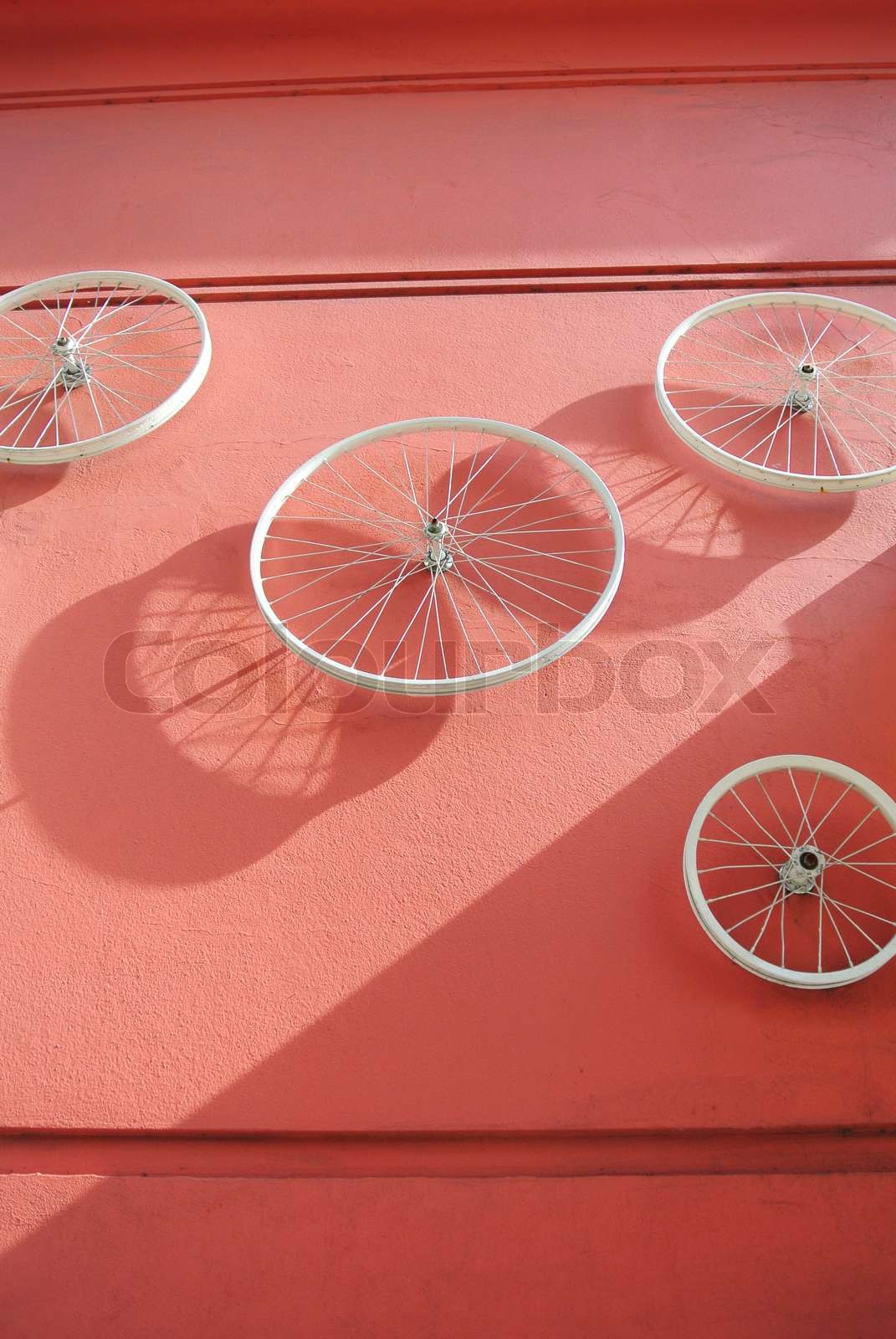 Bicycle wheels mounted on the wall Stock image Colourbox