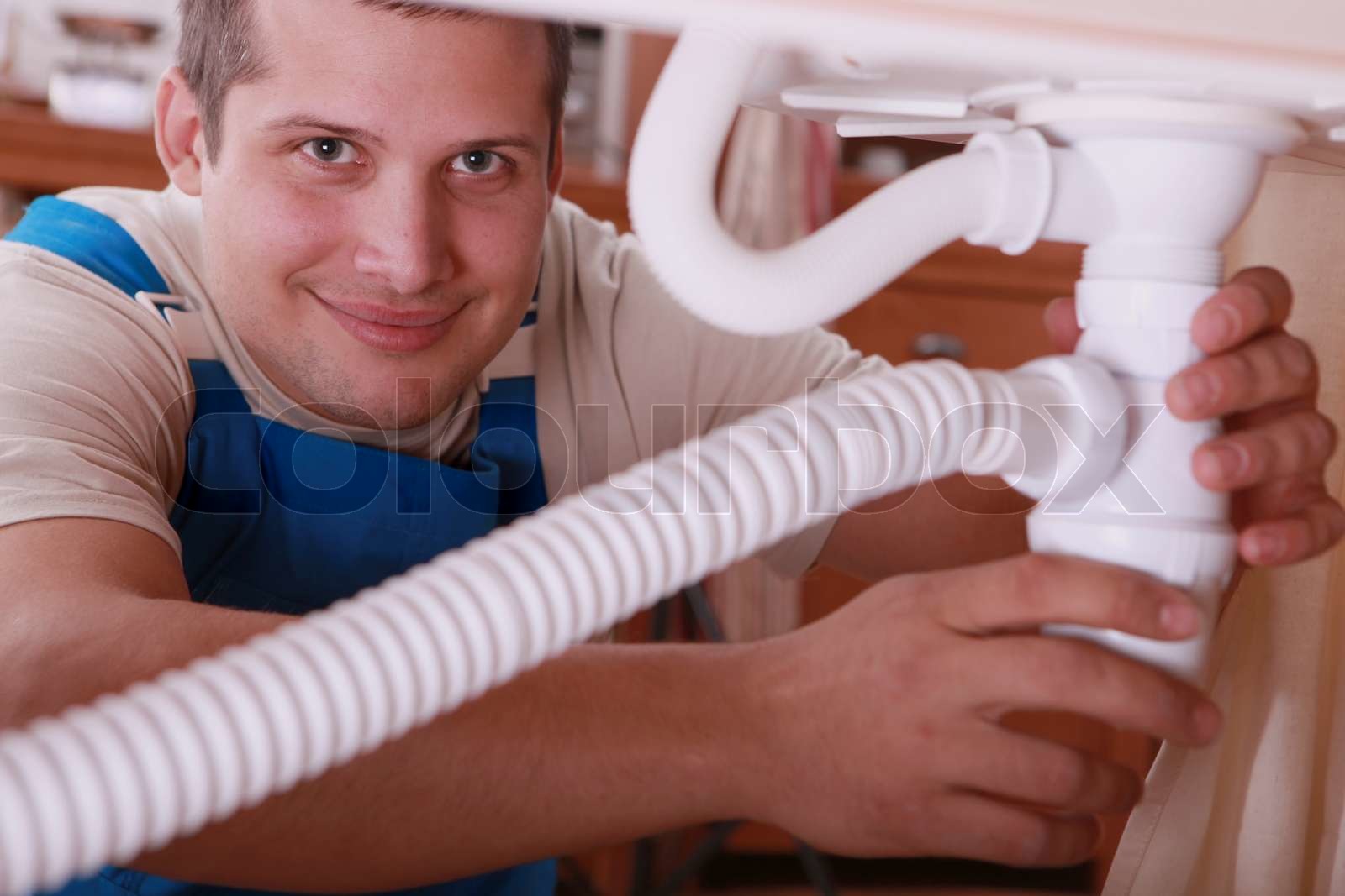 Plumber Fitting A Kitchen Sink Stock Image Colourbox