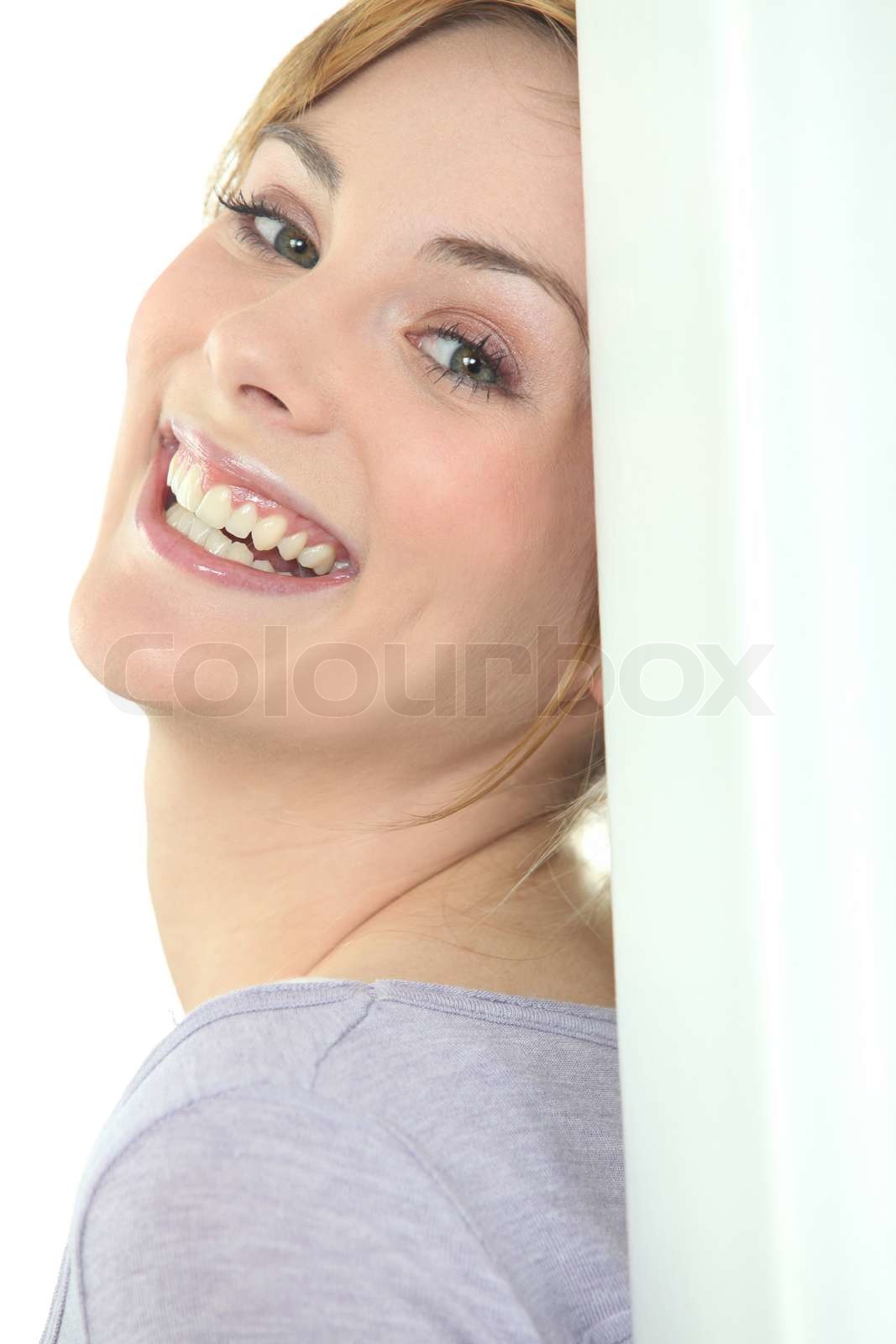 Pretty woman leaning against wall | Stock image | Colourbox