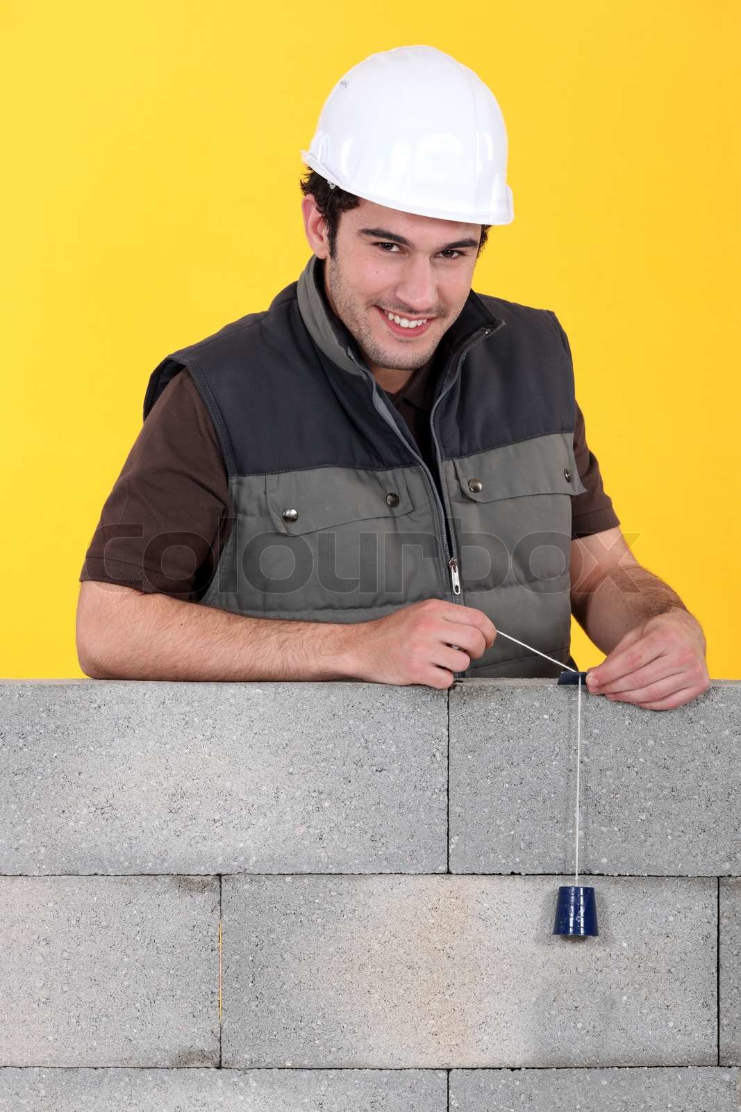 Überprüfung seiner Mauer Maurer Stock Bild Colourbox