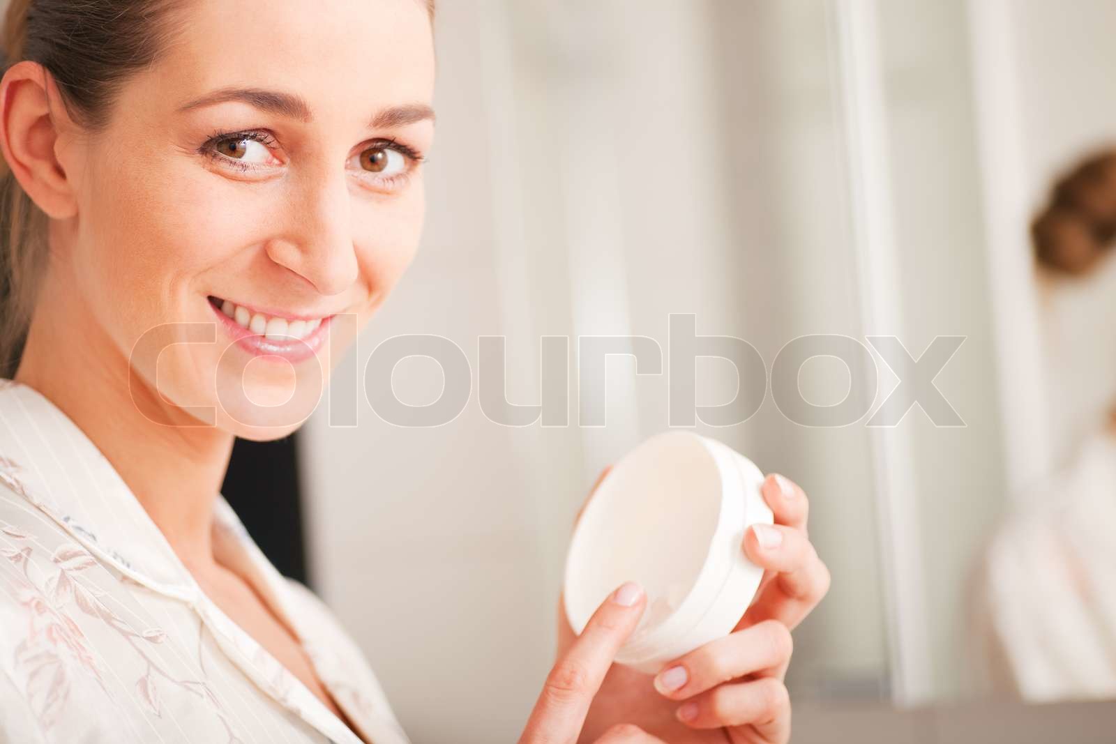 Woman creaming face | Stock image | Colourbox