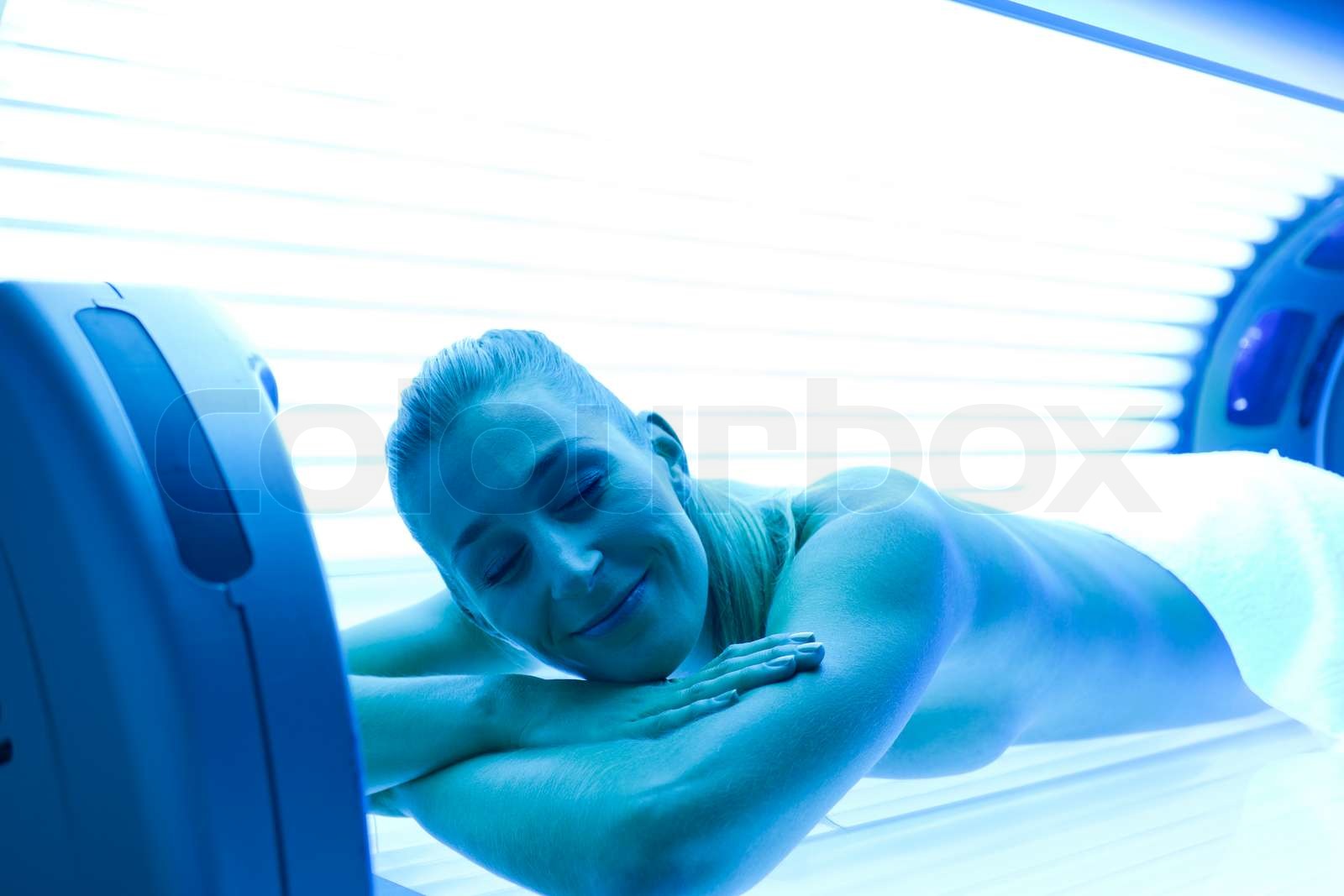 Woman on tanning bed Stock image Colourbox