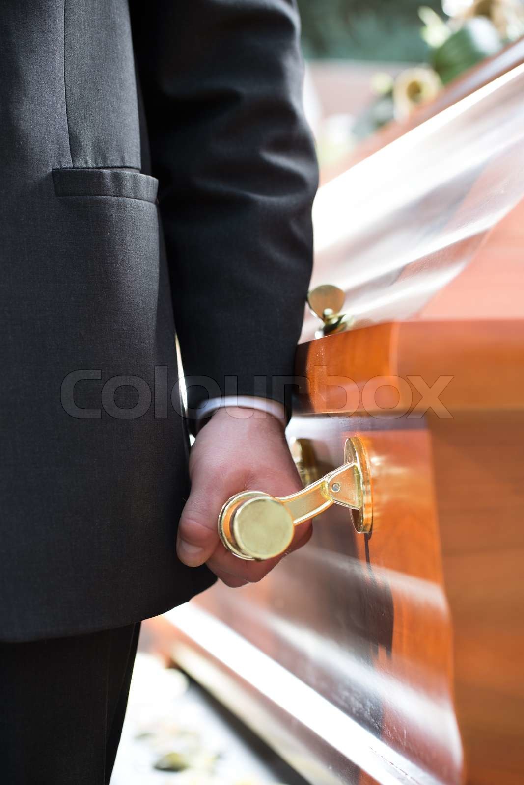 coffin bearer carrying casket at funeral Stock image Colourbox