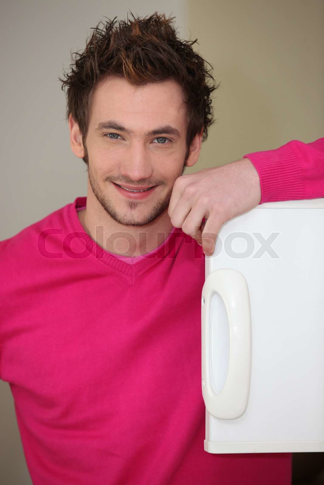 Man looking into a freezer Stock image Colourbox