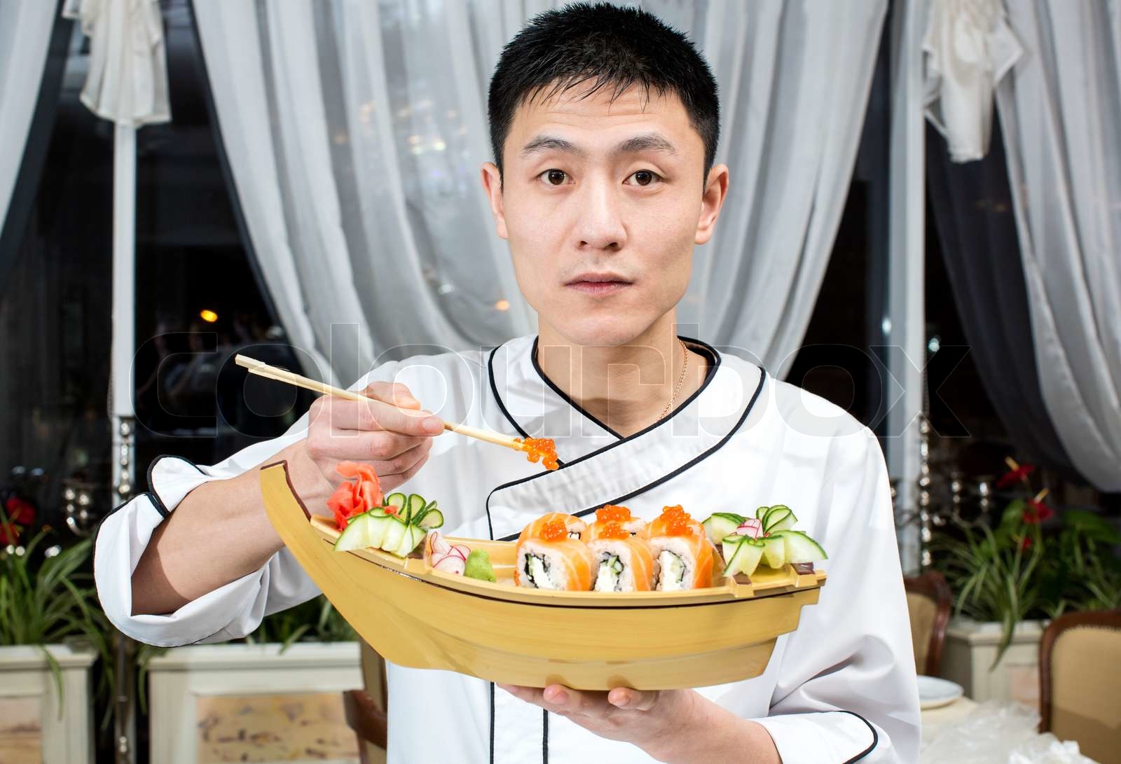 Japanese chef preparing a meal in a restaurant | Stock image | Colourbox