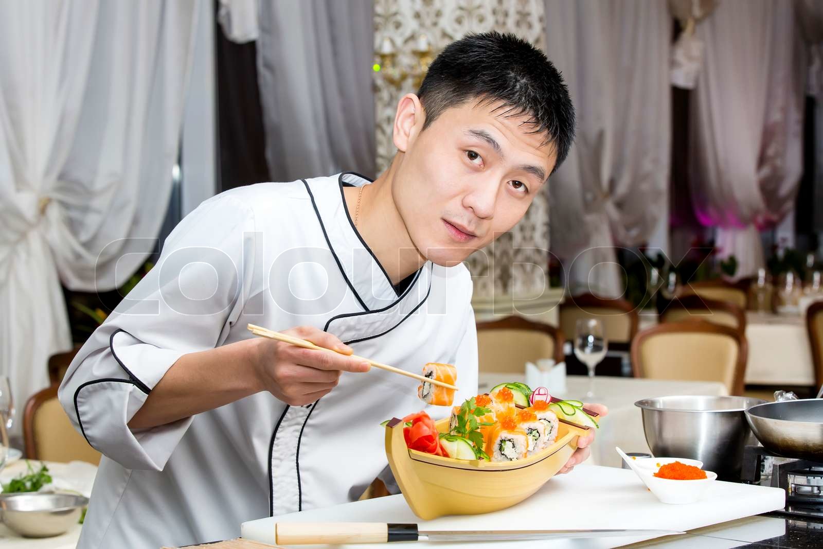 Japanese chef preparing a meal in a restaurant | Stock image | Colourbox