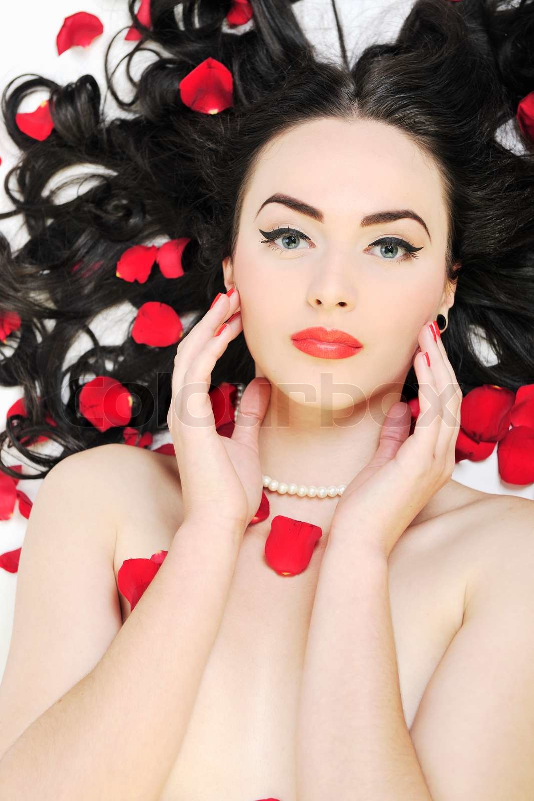 beautiful young nude woman with roses isolated on white Stock image